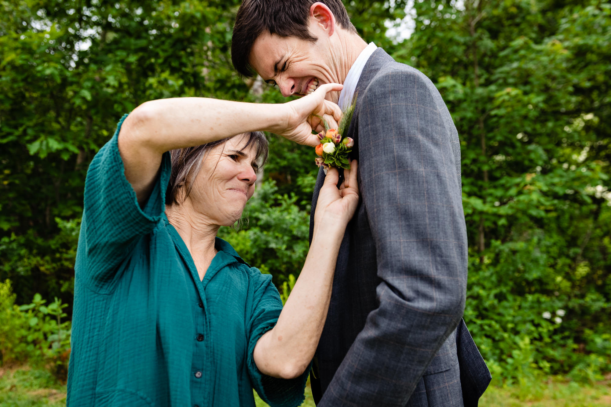 The mother of the groom helps the groom get ready at his Chebeague Island wedding