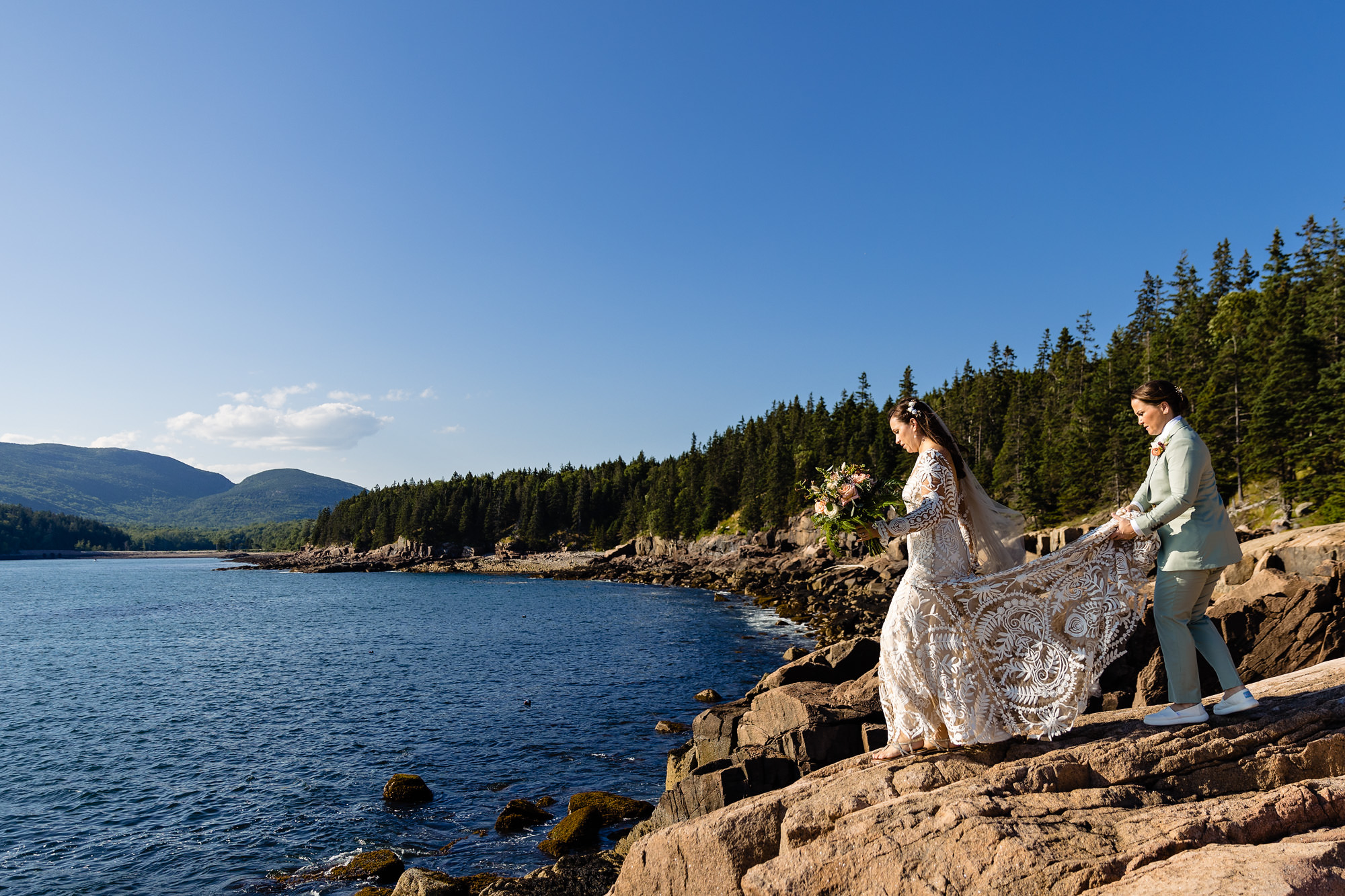 The two brides take some dramatic portraits on the cliffs of Acadia
