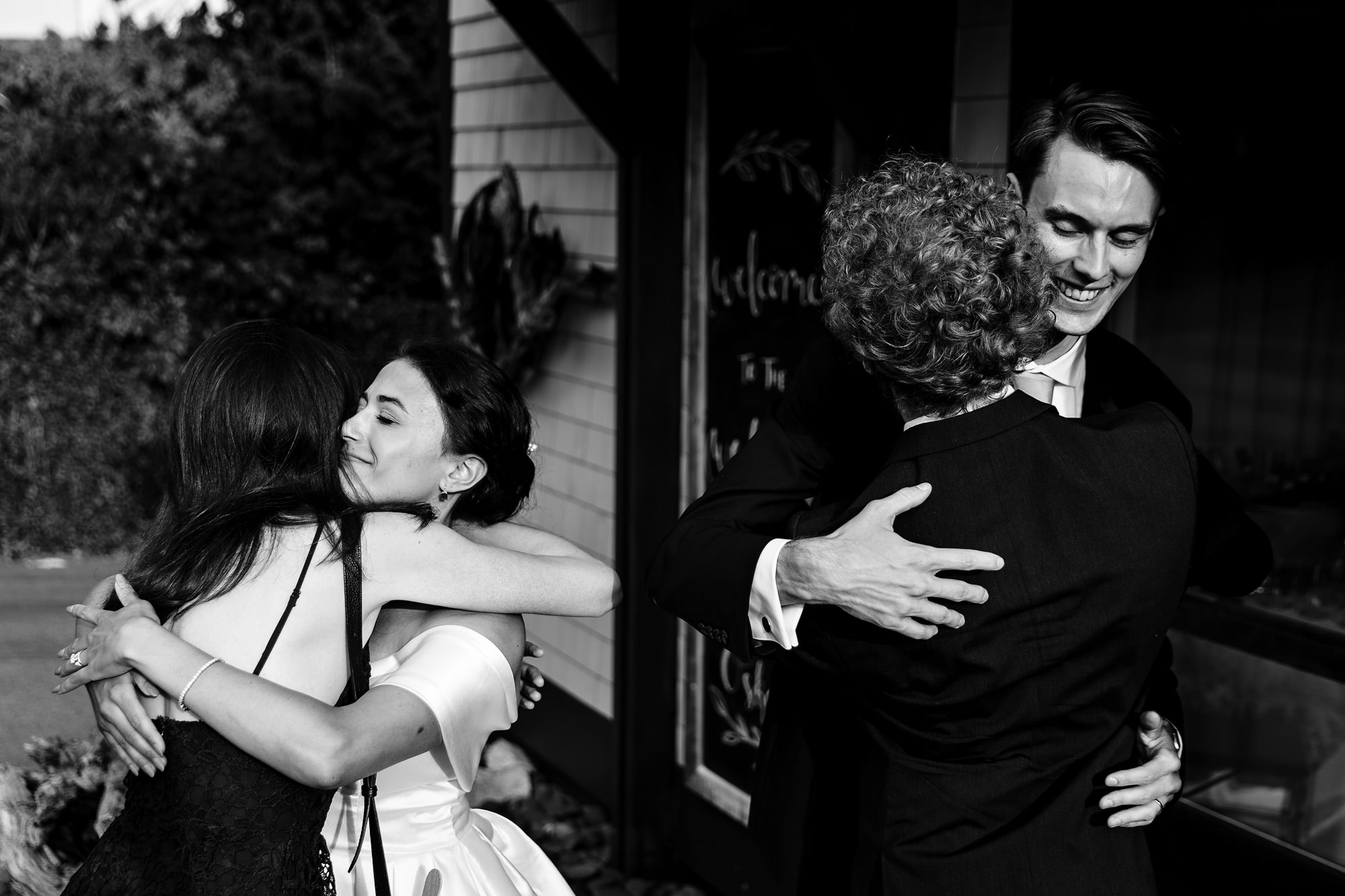 The bride and groom hug guests as they arrive to The View at Pepperrell Cove