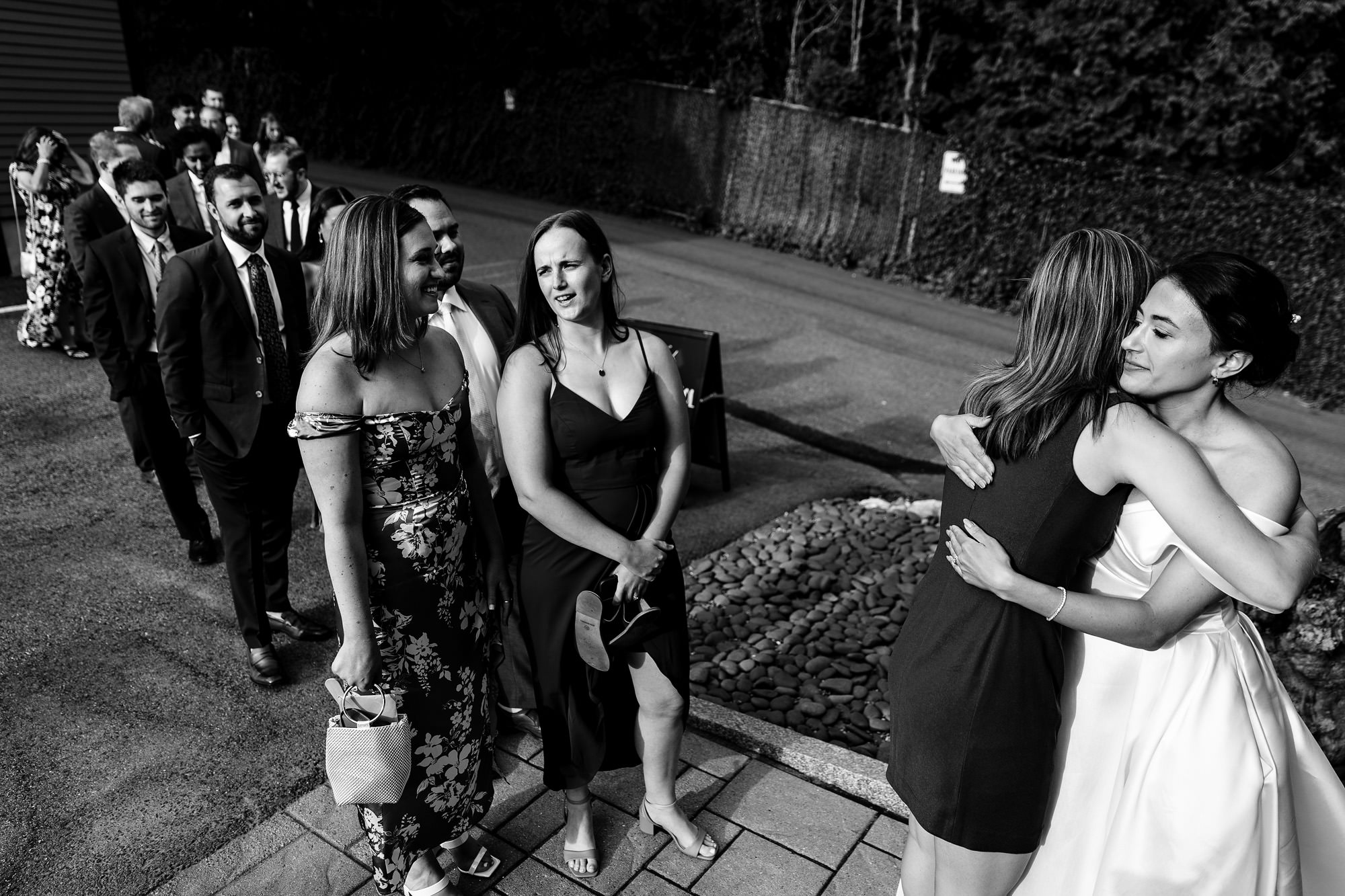 The bride hugs guests as they arrive to The View at Pepperrell Cove