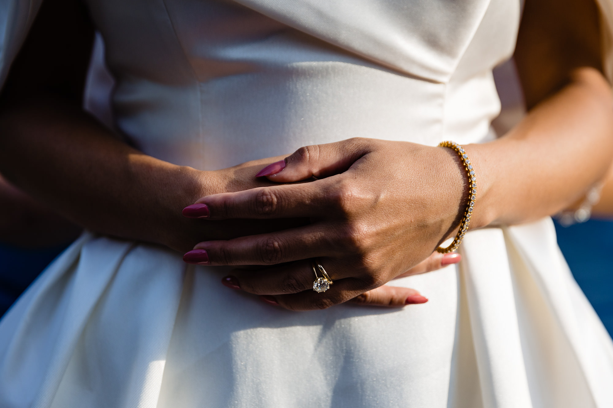 The bride's hands lit in golden light.