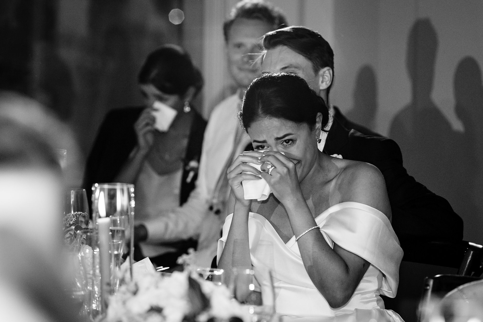 The bride cries during a toast by her maid of honor at their Kittery Point Maine wedding