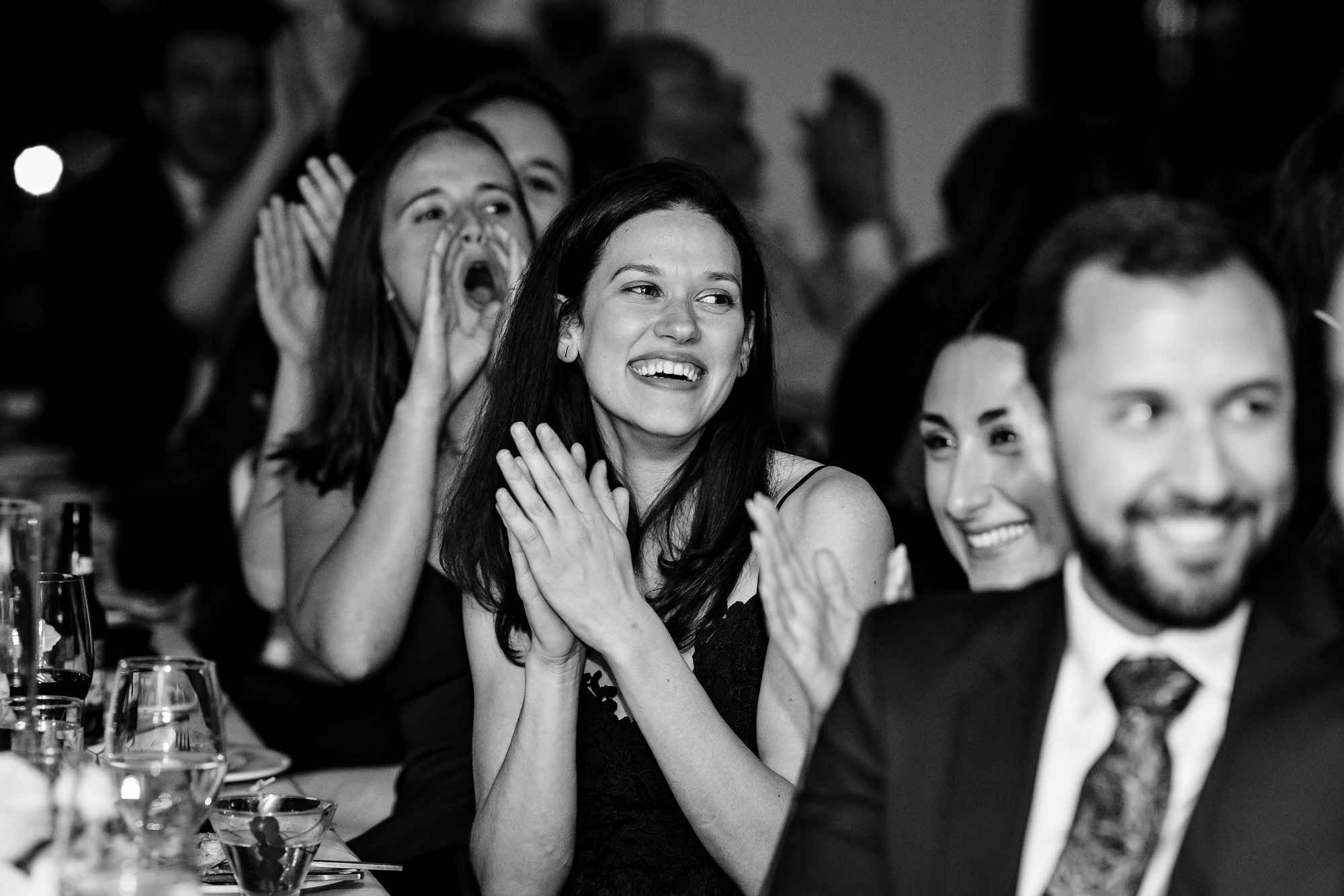 Guests cheer during a wedding toast at a Kittery Point Maine wedding