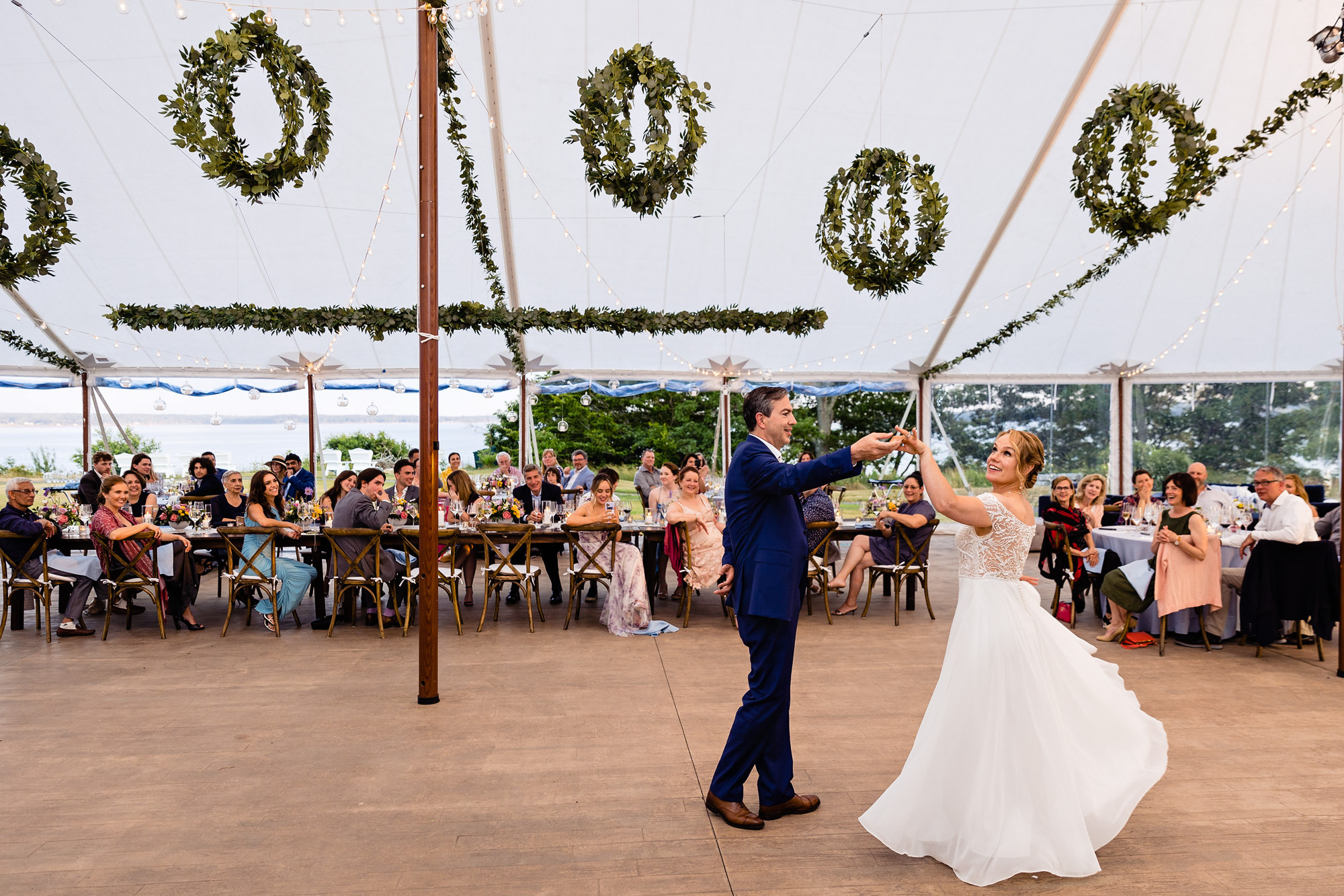 A wedding reception under a sailcloth tent at a midcoast wedding in Maine