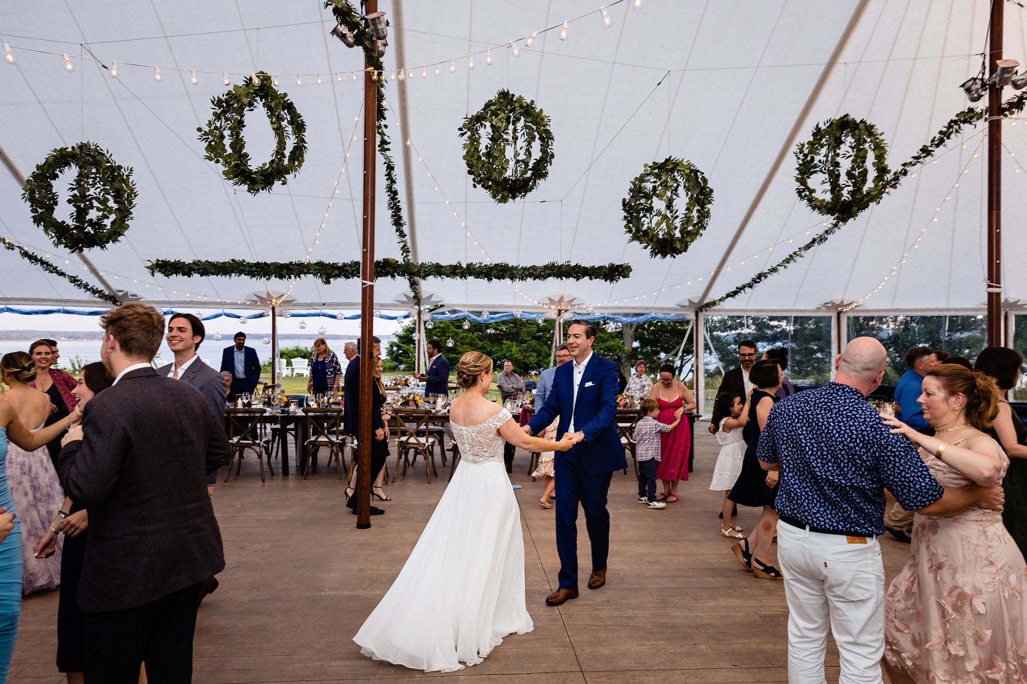 A wedding reception under a sailcloth tent at a midcoast wedding in Maine