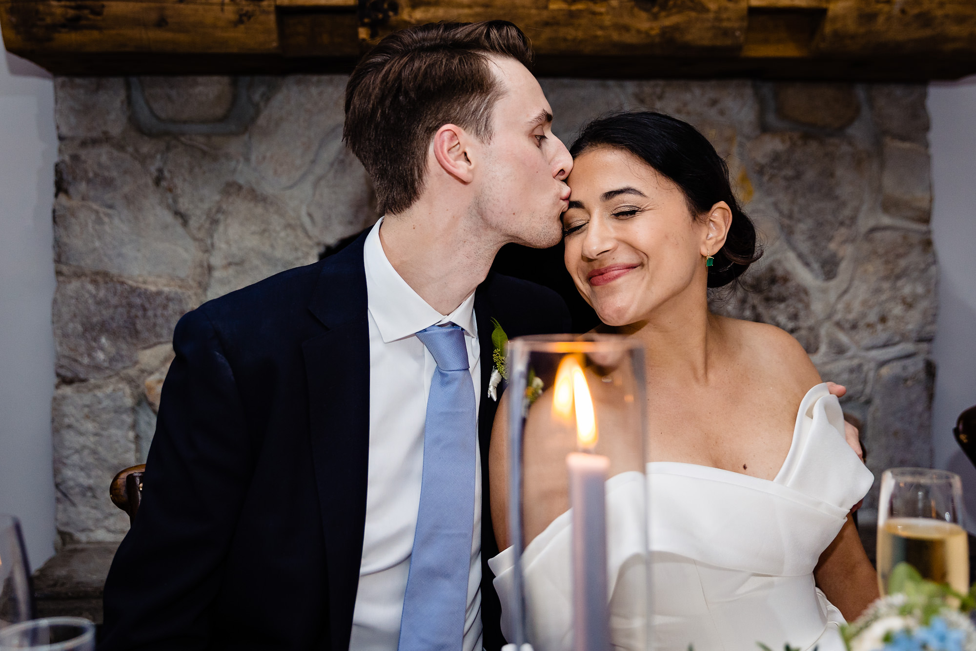The wedding couple react to toasts at their View at Pepperrell Cove wedding reception