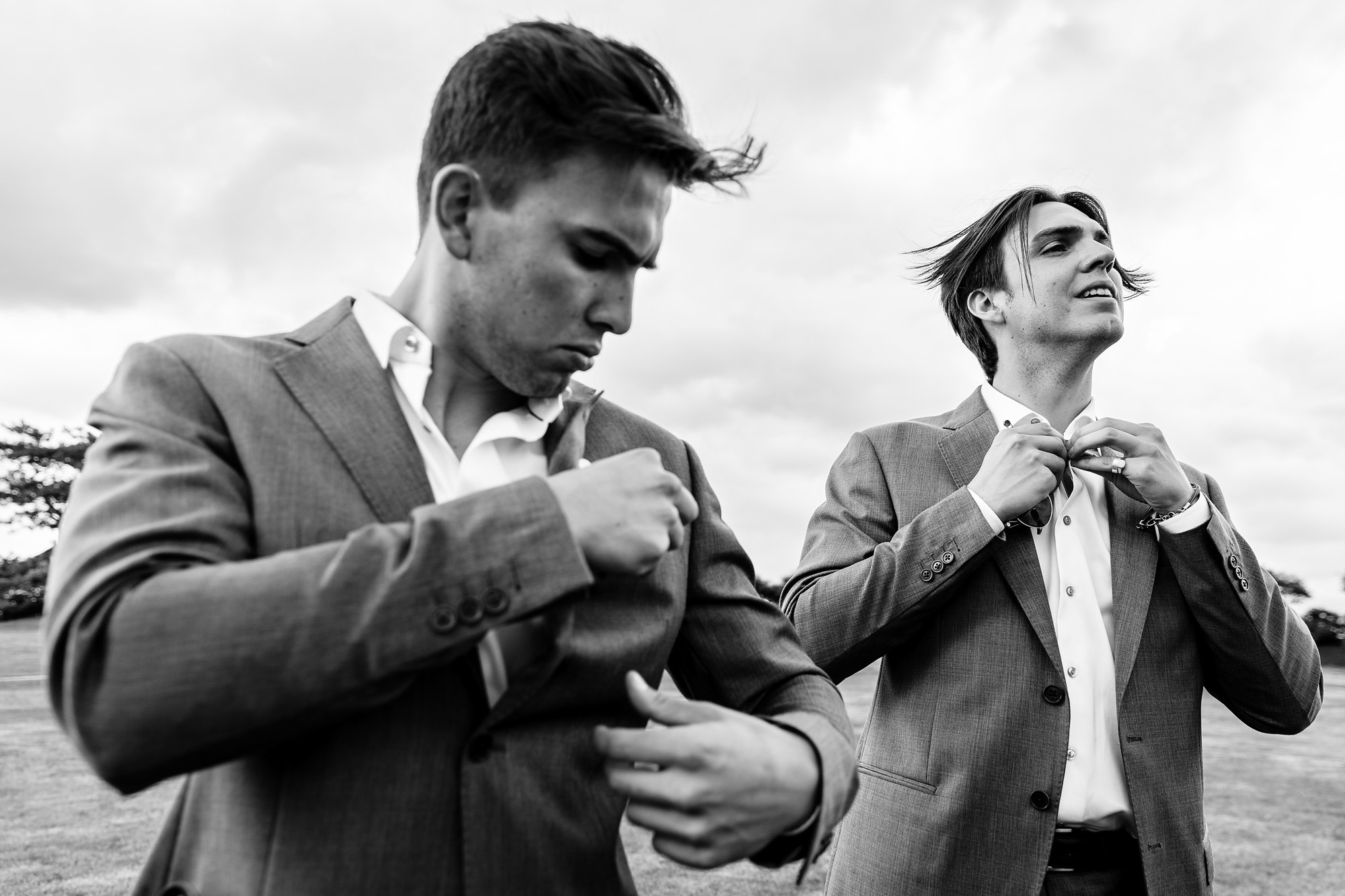 The wedding party preps their pocket squares at a midcoast Maine wedding