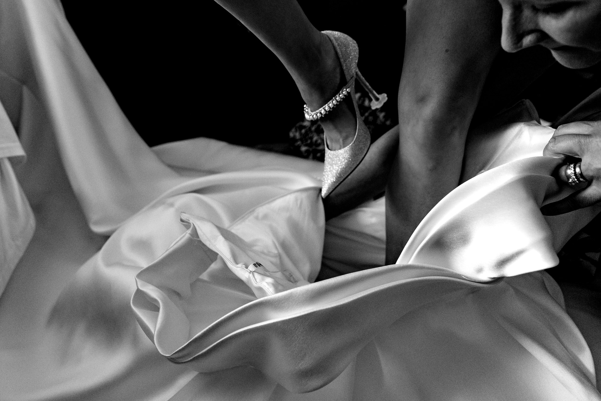 A bride steps into her wedding dres