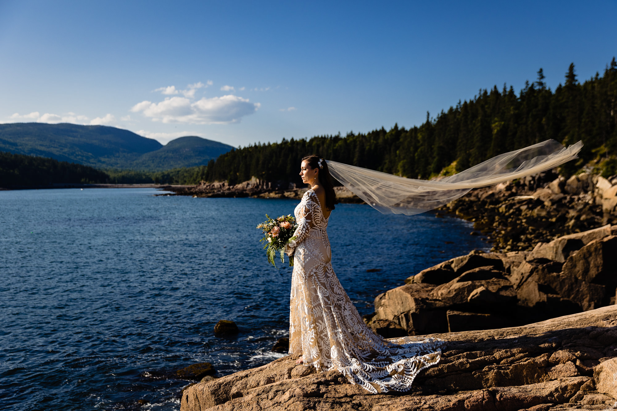 The two brides take some dramatic portraits on the cliffs of Acadia