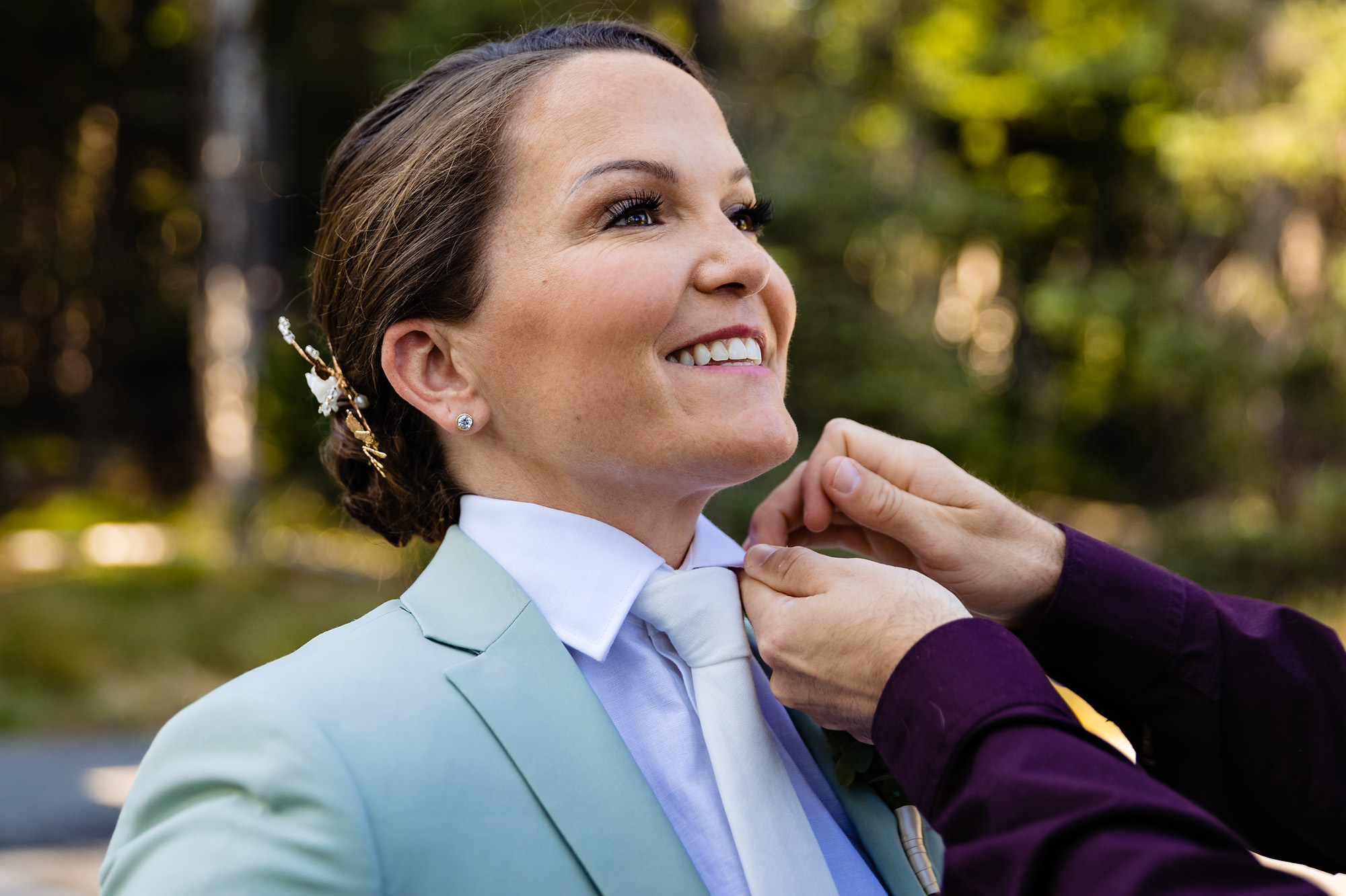 Ali gets some help with getting ready from a friend at her Acadia elopement