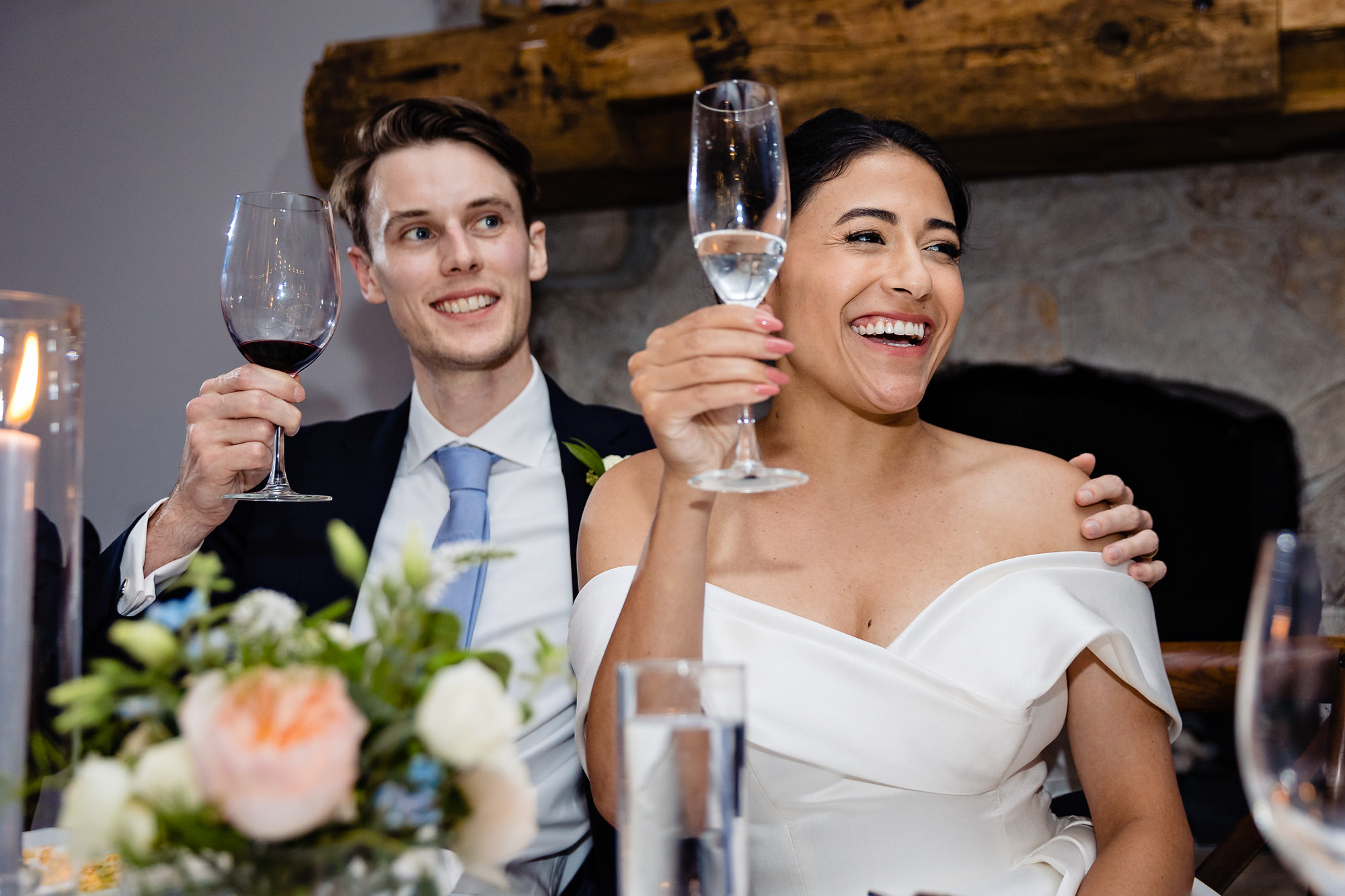 The wedding couple react to toasts at their View at Pepperrell Cove wedding reception