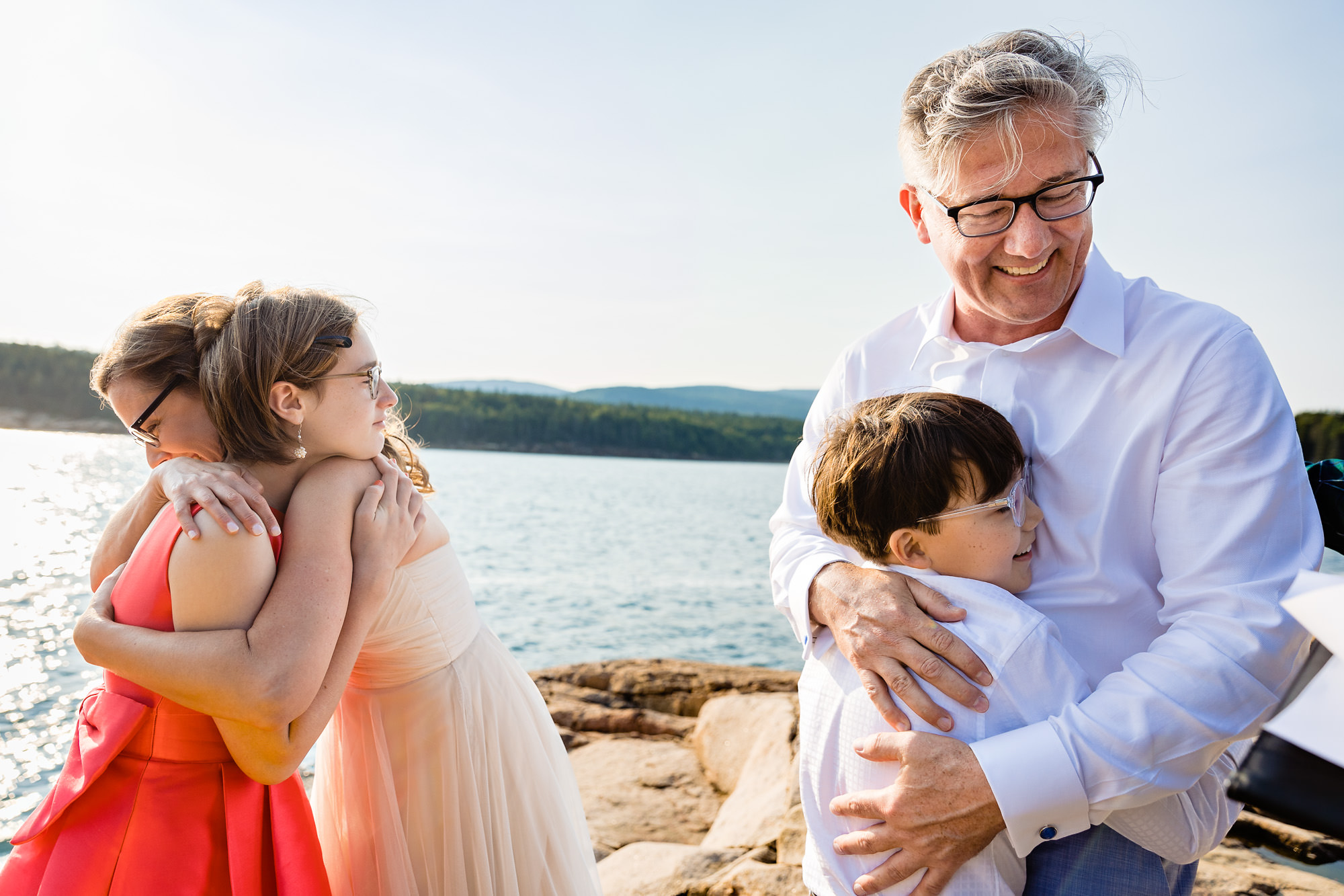 The bride and groom embrace their children after their Acadia elopement