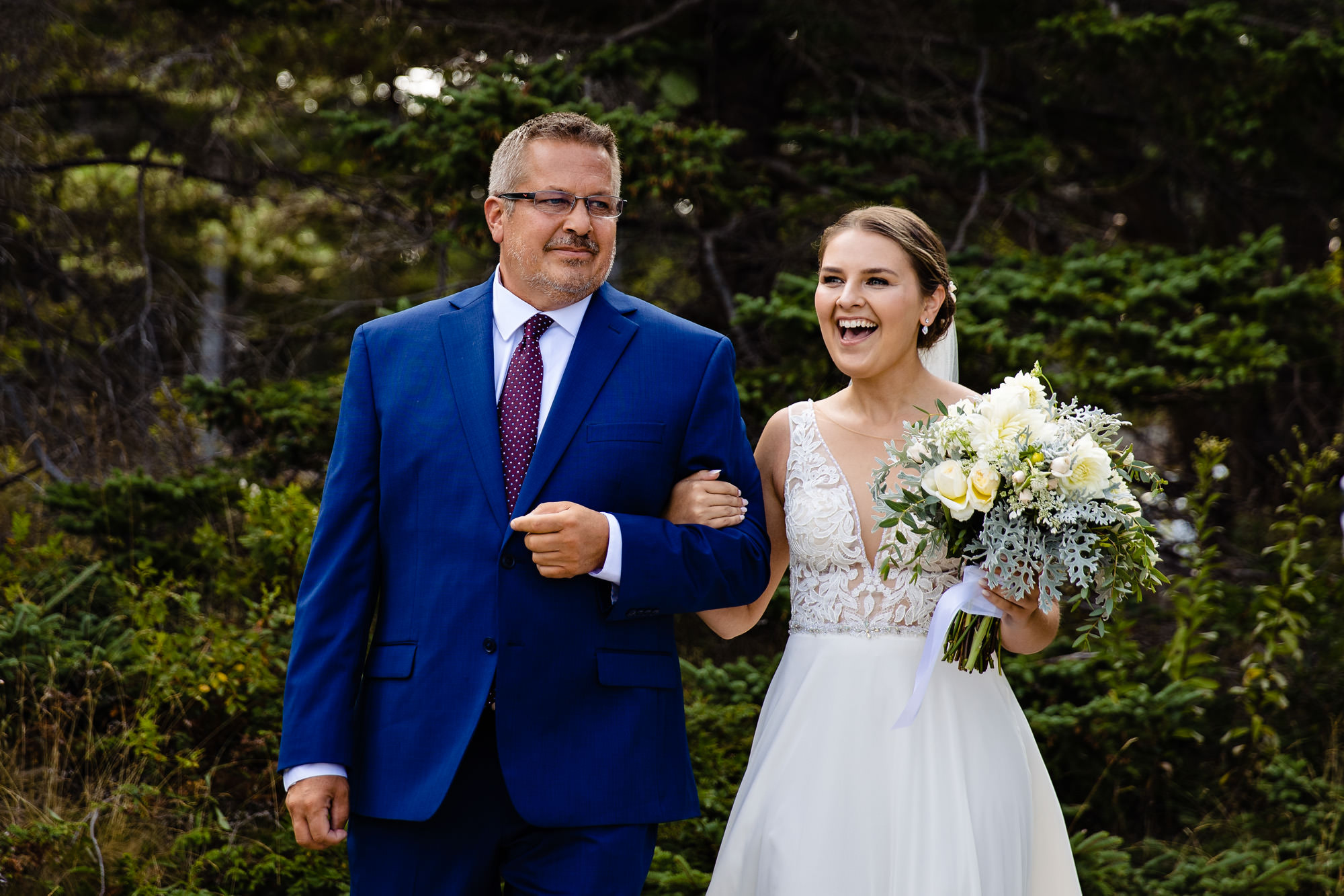 The bride laughs as she walks into her Acadia elopement ceremony