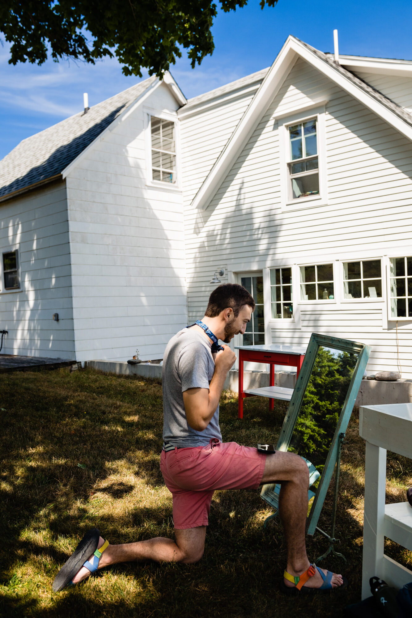 A groom gets ready outside for his wedding on Swans Island, Maine