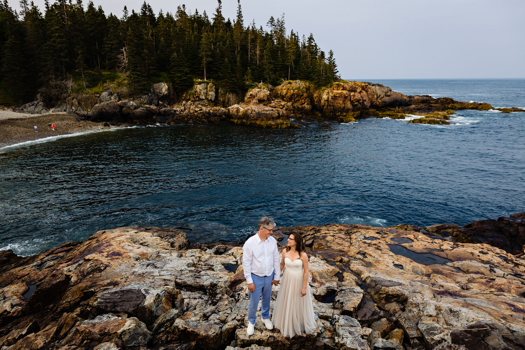 An elopement couple at a rocky beach in Acadia National Park