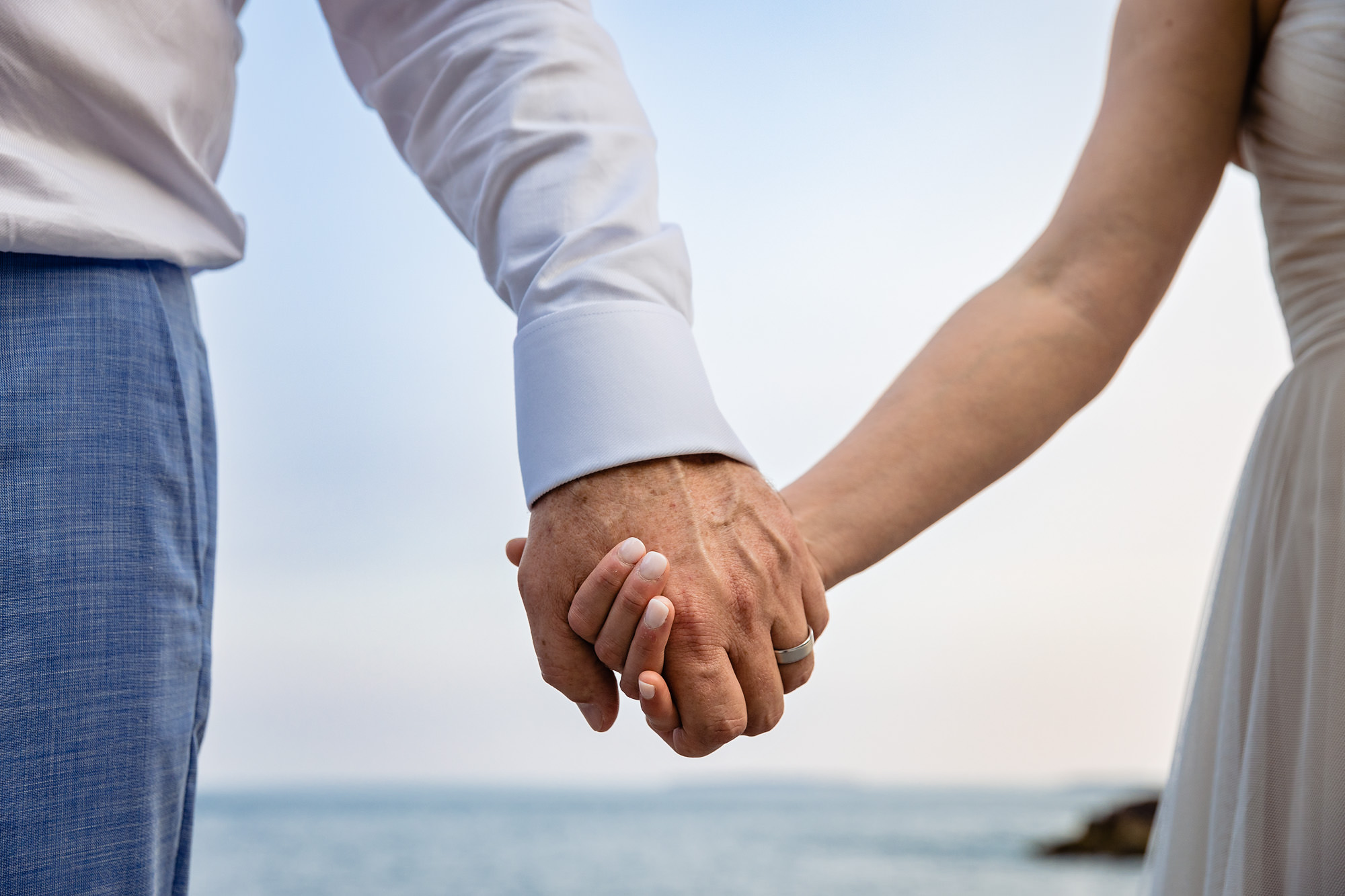 A bride and groom hold hands at an Acadia elopement