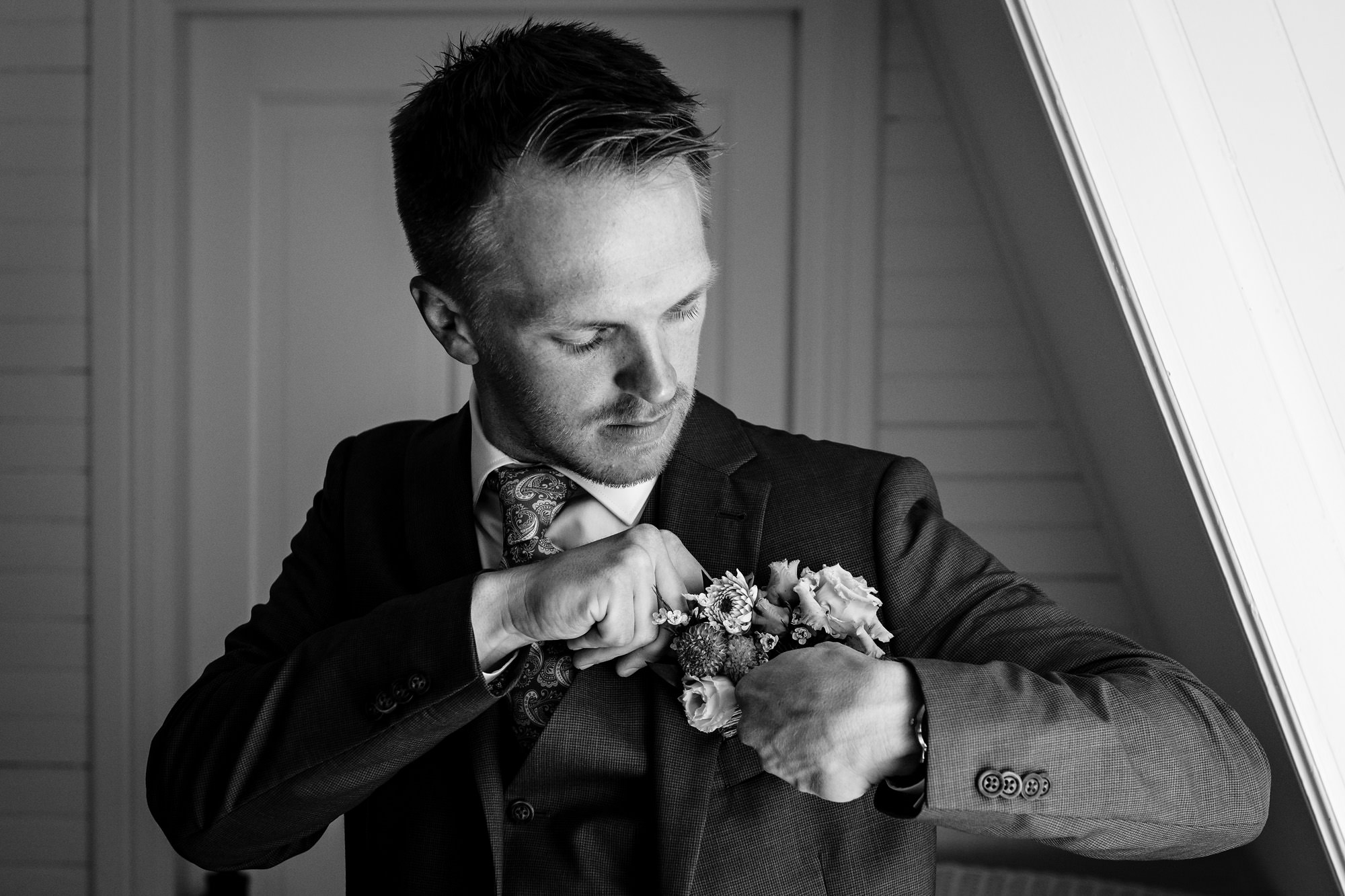 A groom gets dressed for his wedding in Georgetown Maine
