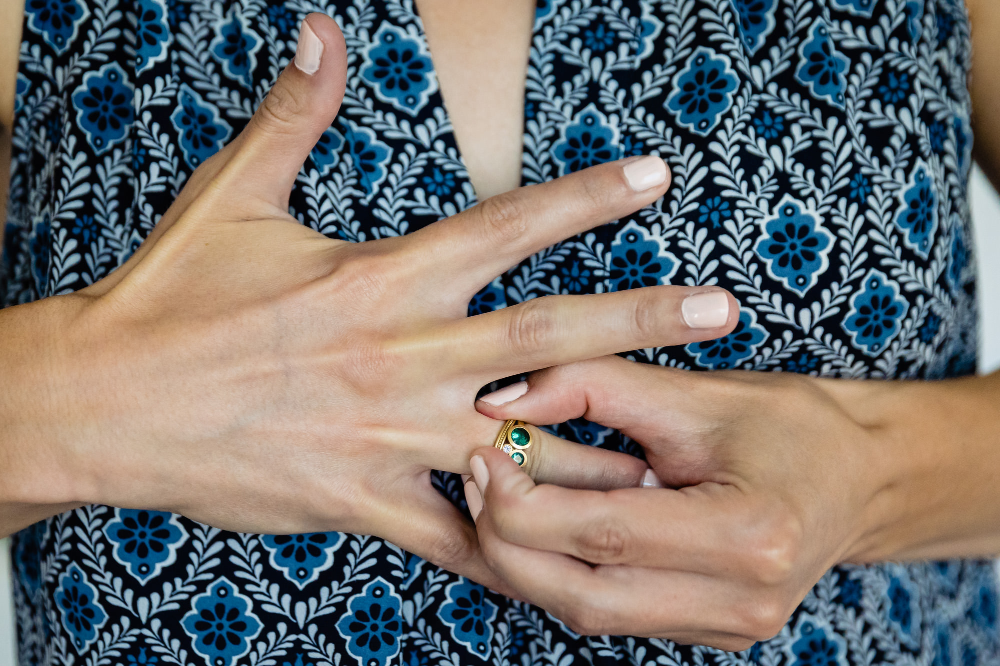 A bride moves her ring to the other hand while preparing for her Georgetown Maine wedding