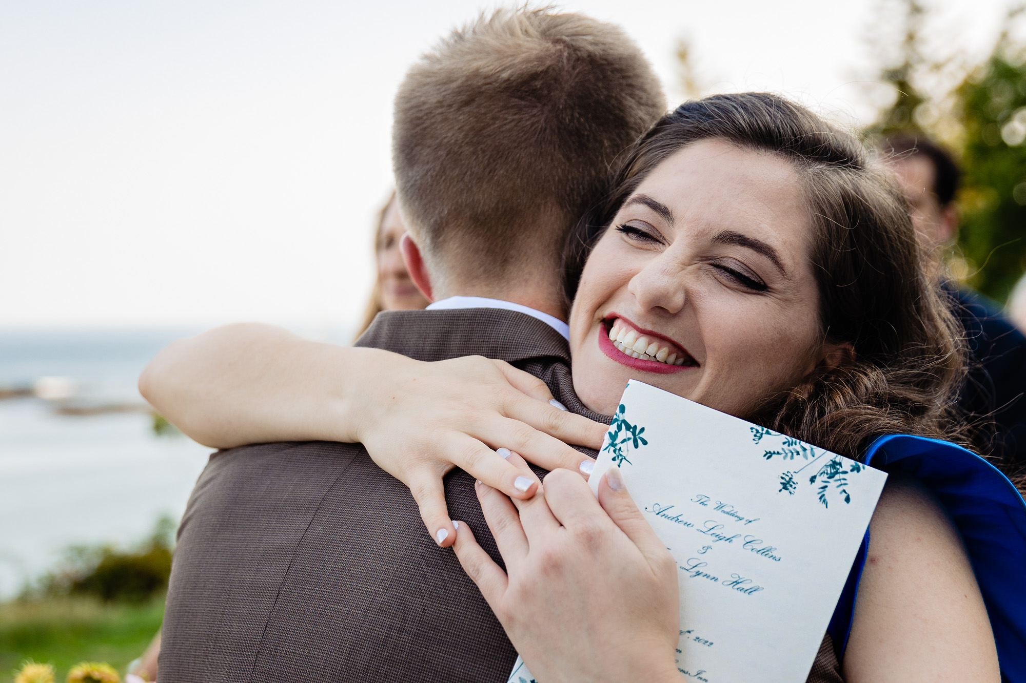 Hugs after a stunning coastal wedding ceremony in Georgetown, Maine