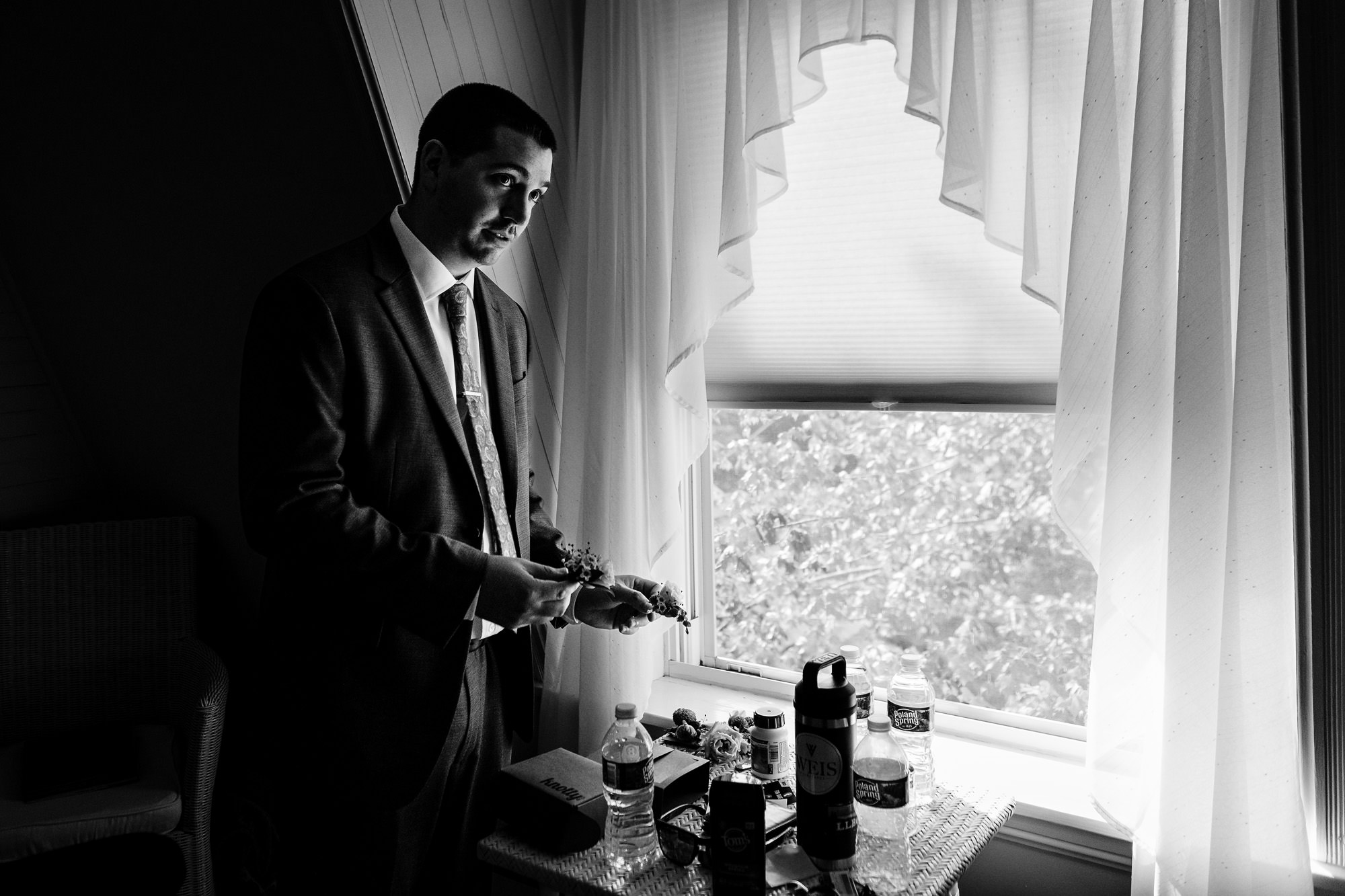 A groom gets dressed for his wedding in Georgetown Maine