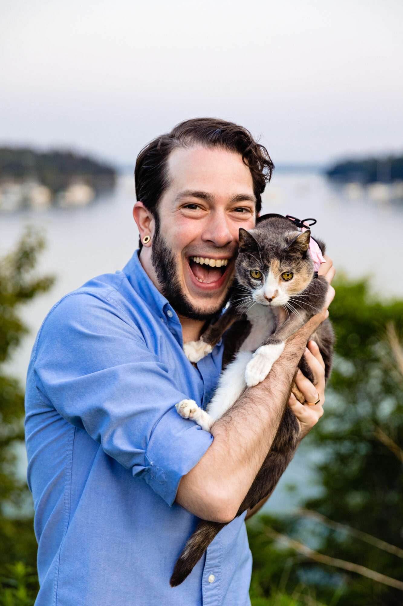 A photo of a man holding a cat in Northeast Harbor, Maine