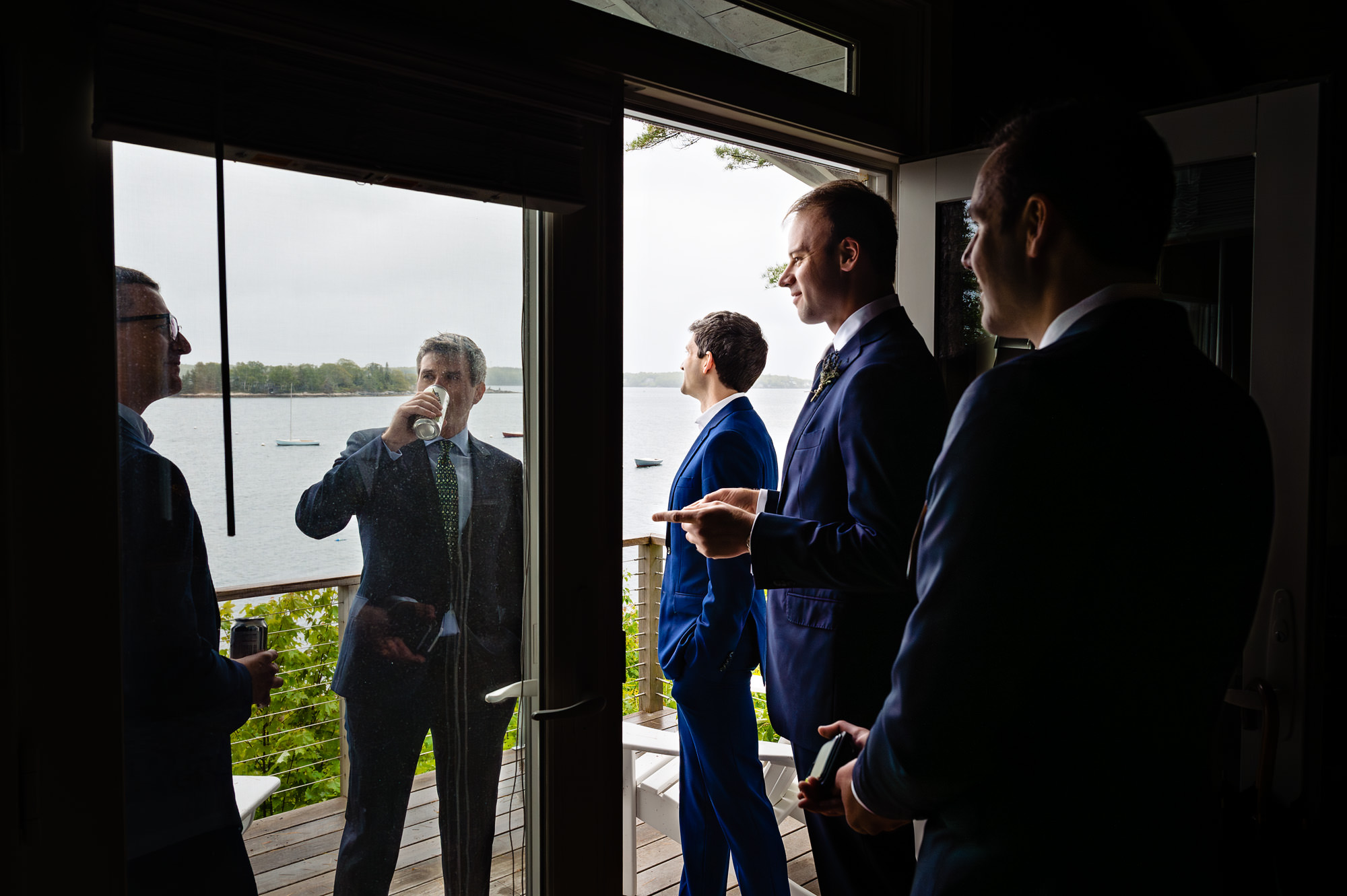 The groom and his friends relax before his Linekin Bay Resort wedding in Boothbay Harbor, Maine