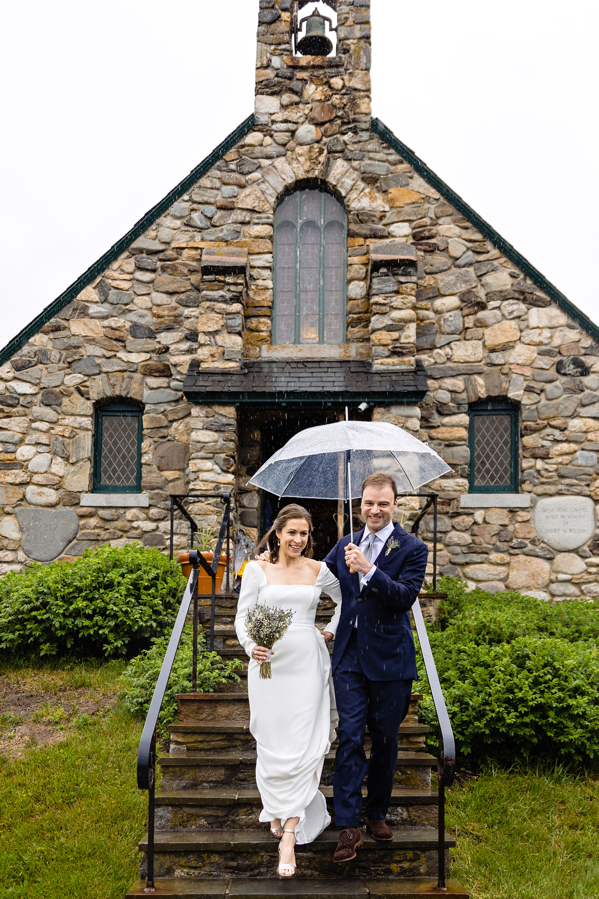 A wedding couple leave the Wilson Memorial Chapel wedding ceremony on a rainy day.