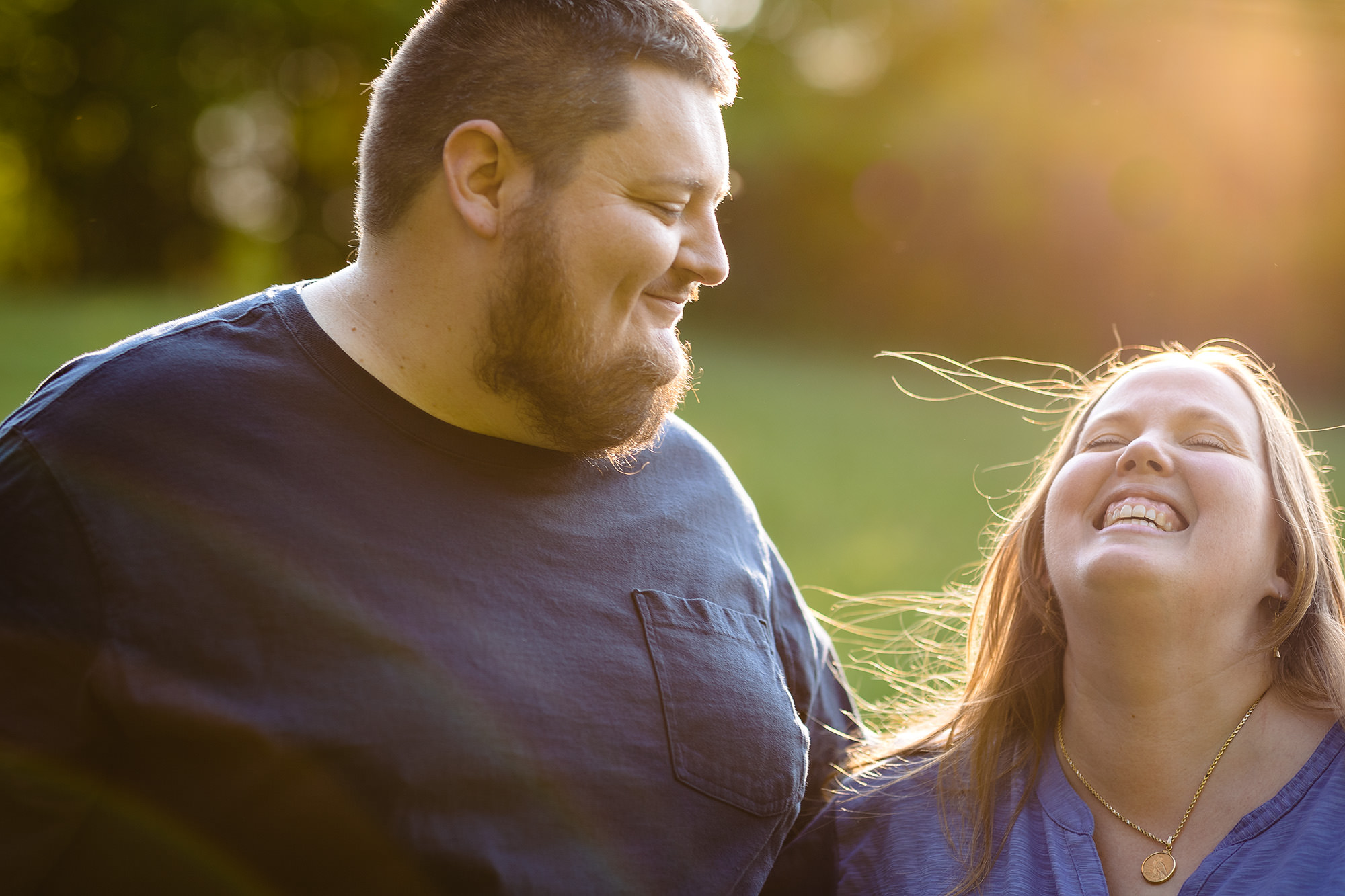 A couple laughs during their Winterport Maine engagement session