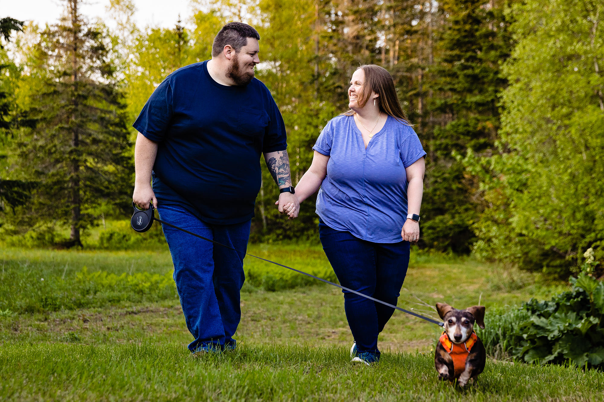 A couple walks their dog at their Winterport Maine engagement session