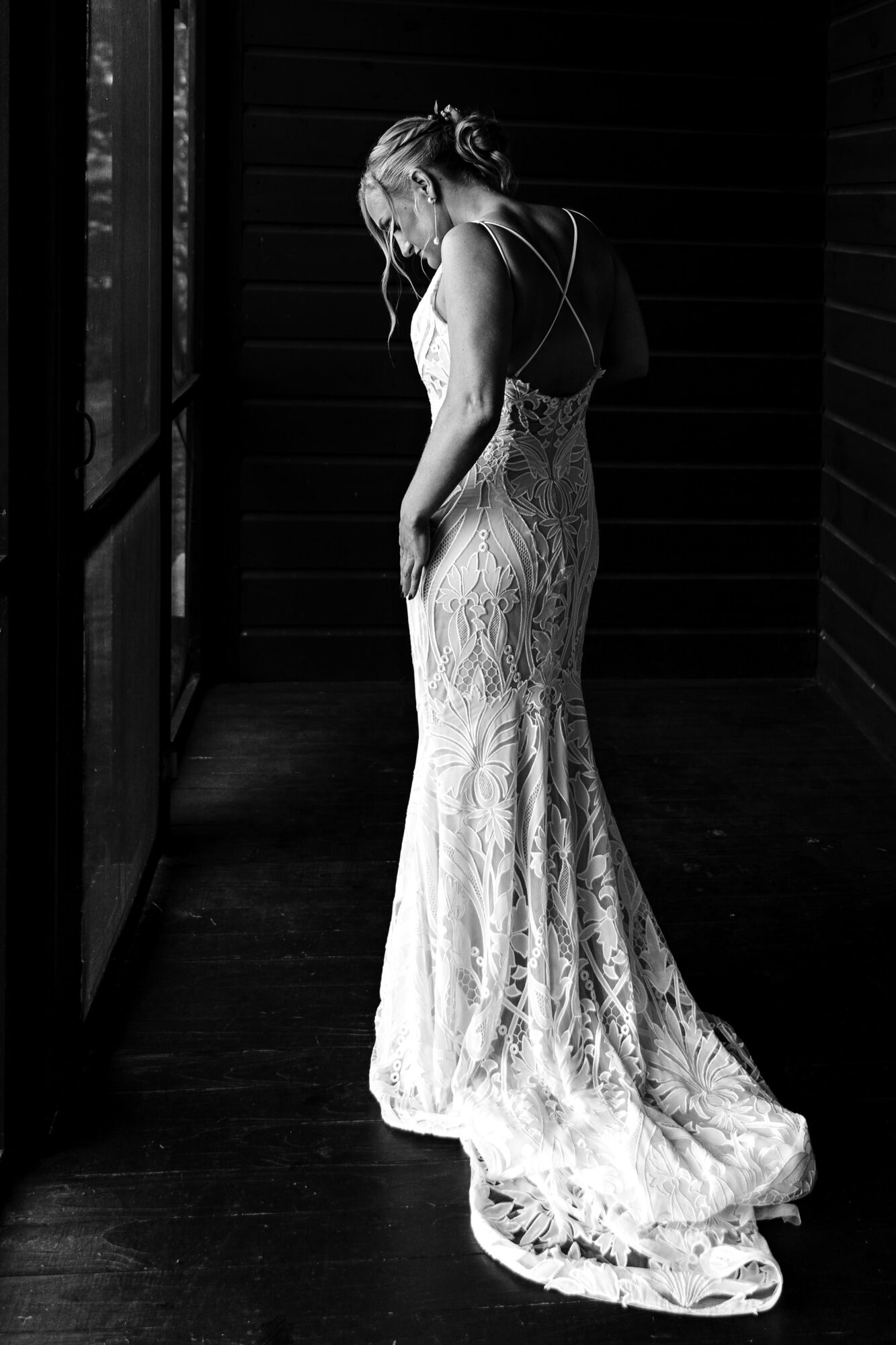 A bride puts on her wedding dress at her Meredith NH wedding ceremony