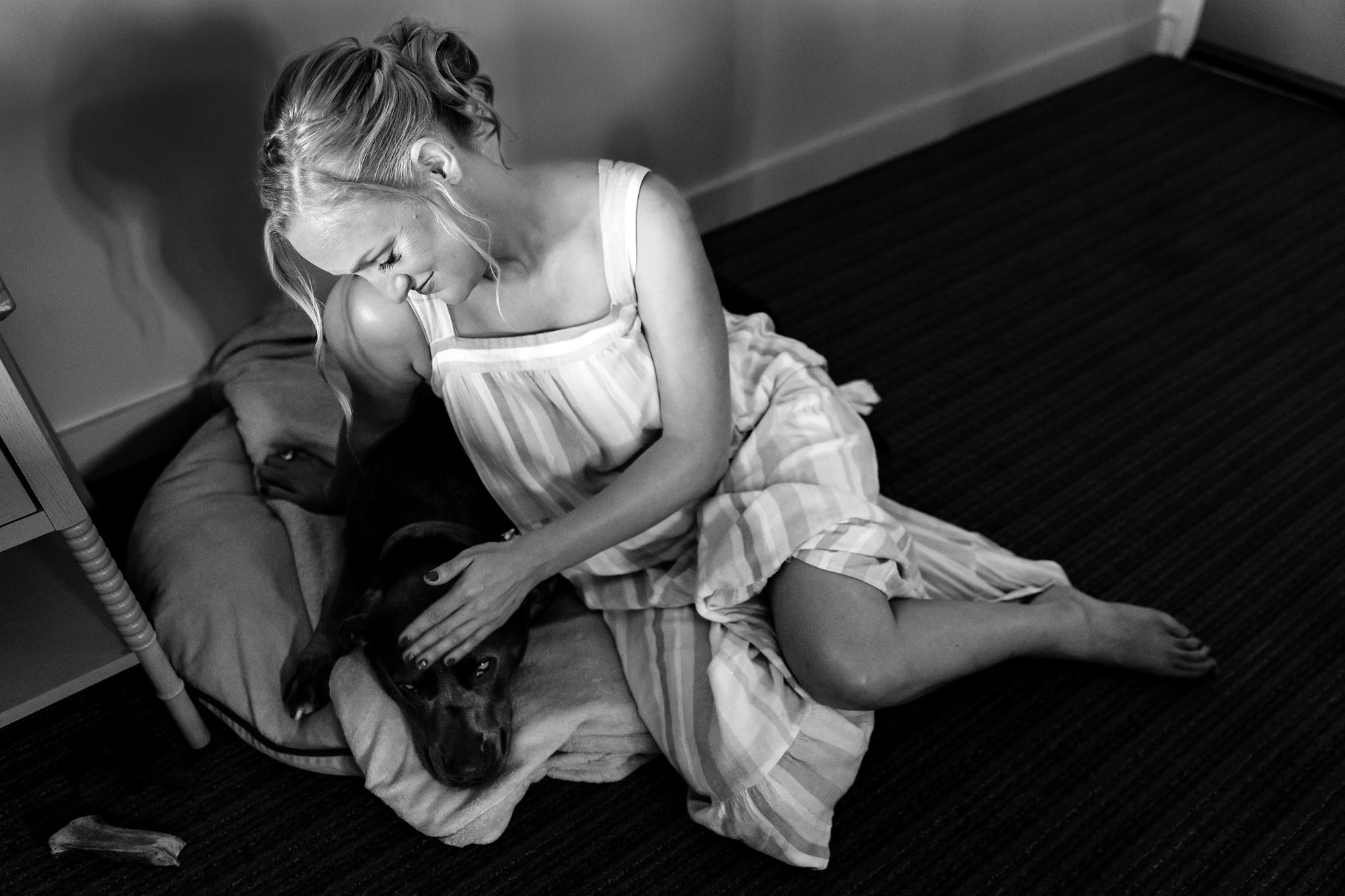 A bride pets her dog before her Mills Falls at Church Landing wedding ceremony