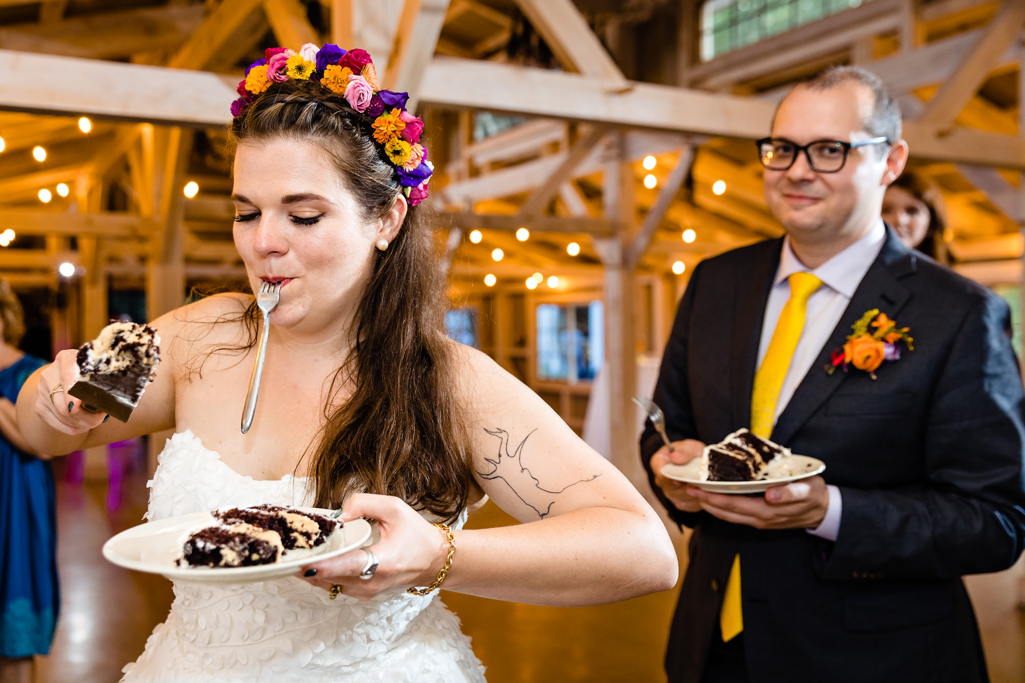 A cake cutting at a wedding in a barn in Maine