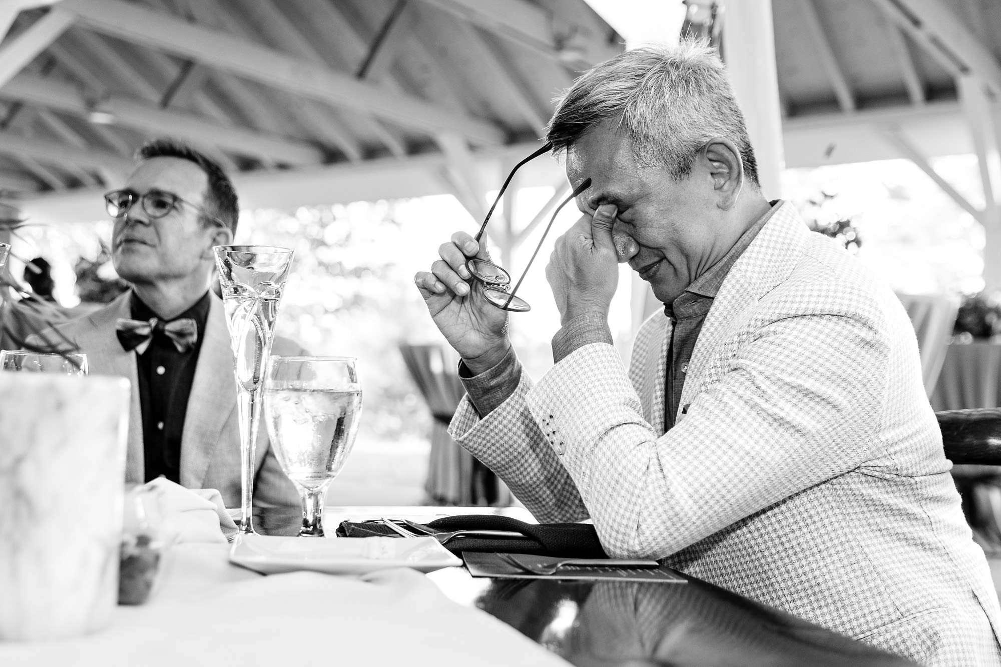 The grooms listen to toasts at their Rangeley Inn wedding in Maine