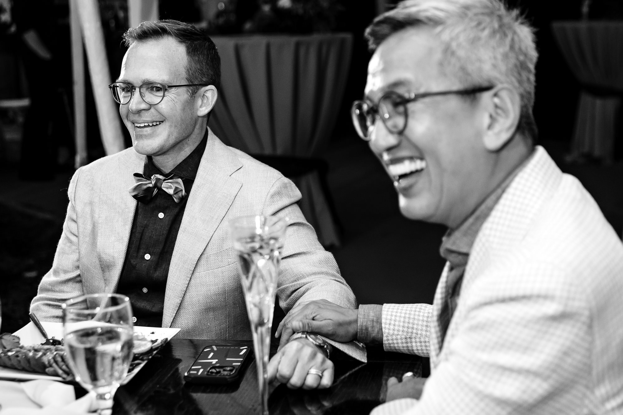 The grooms react to toasts during their wedding in Rangeley, Maine