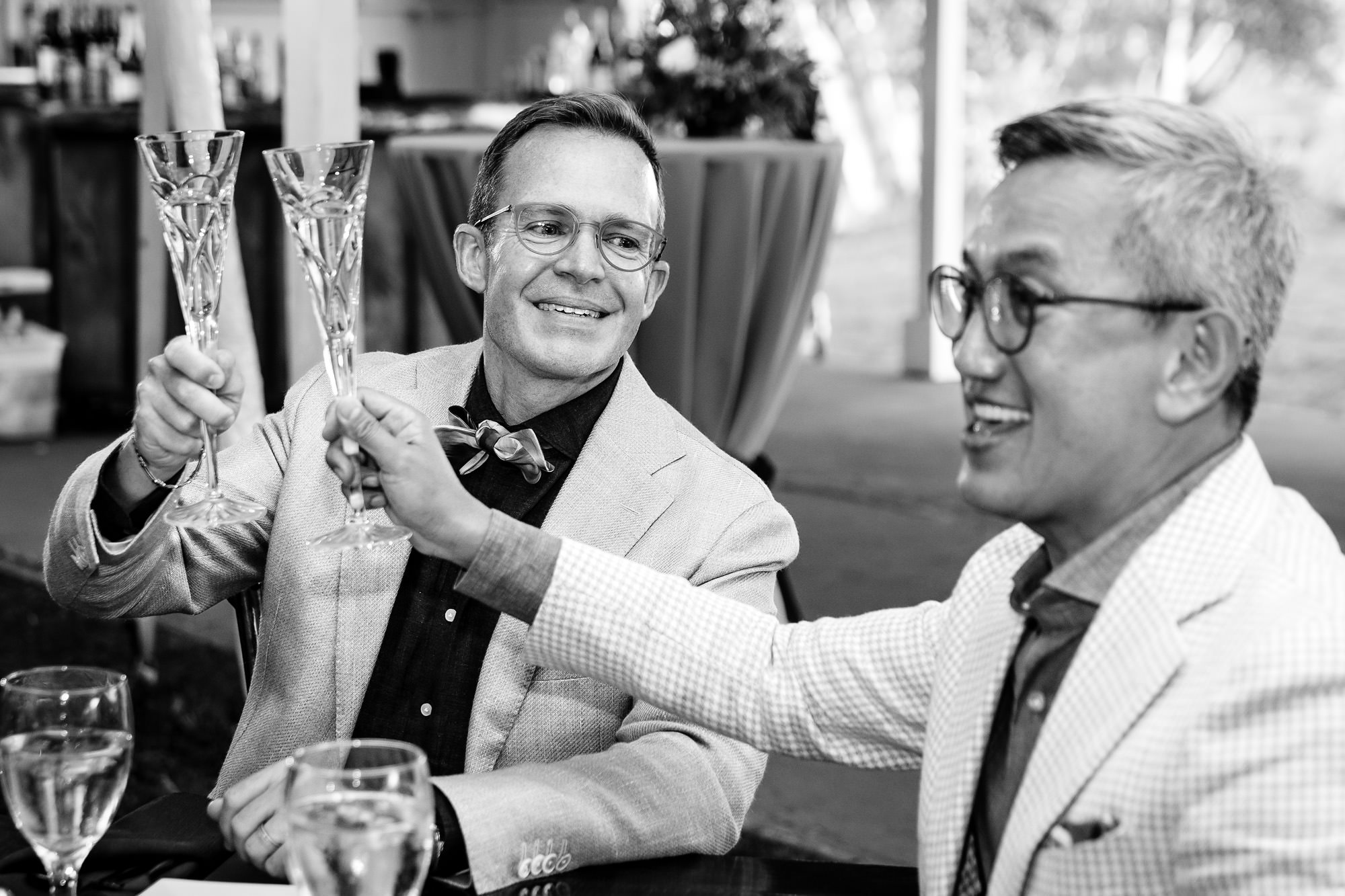 The grooms listen to toasts at their Rangeley Inn wedding in Maine