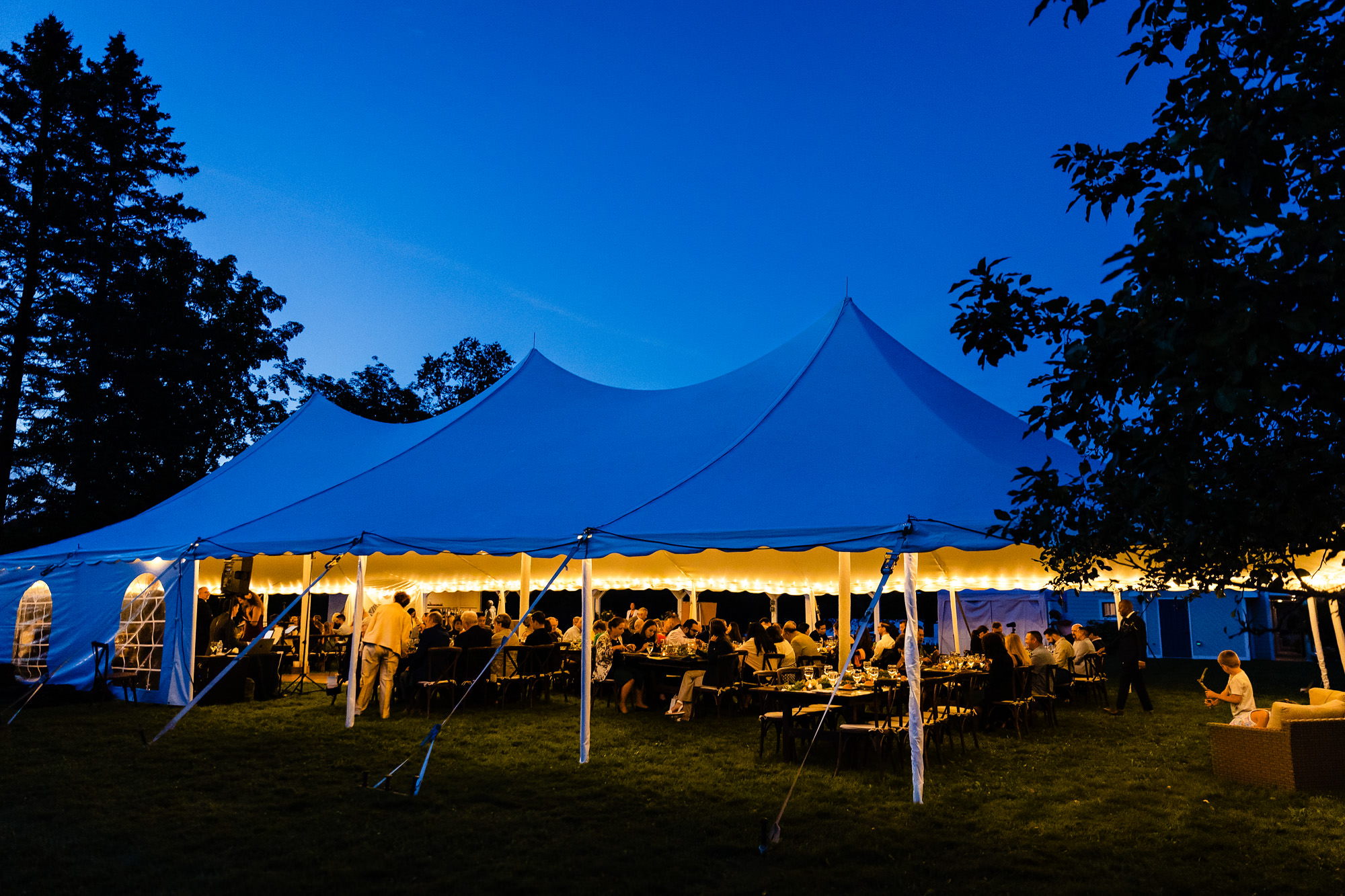 A wedding tent in Rangeley Maine at twilight