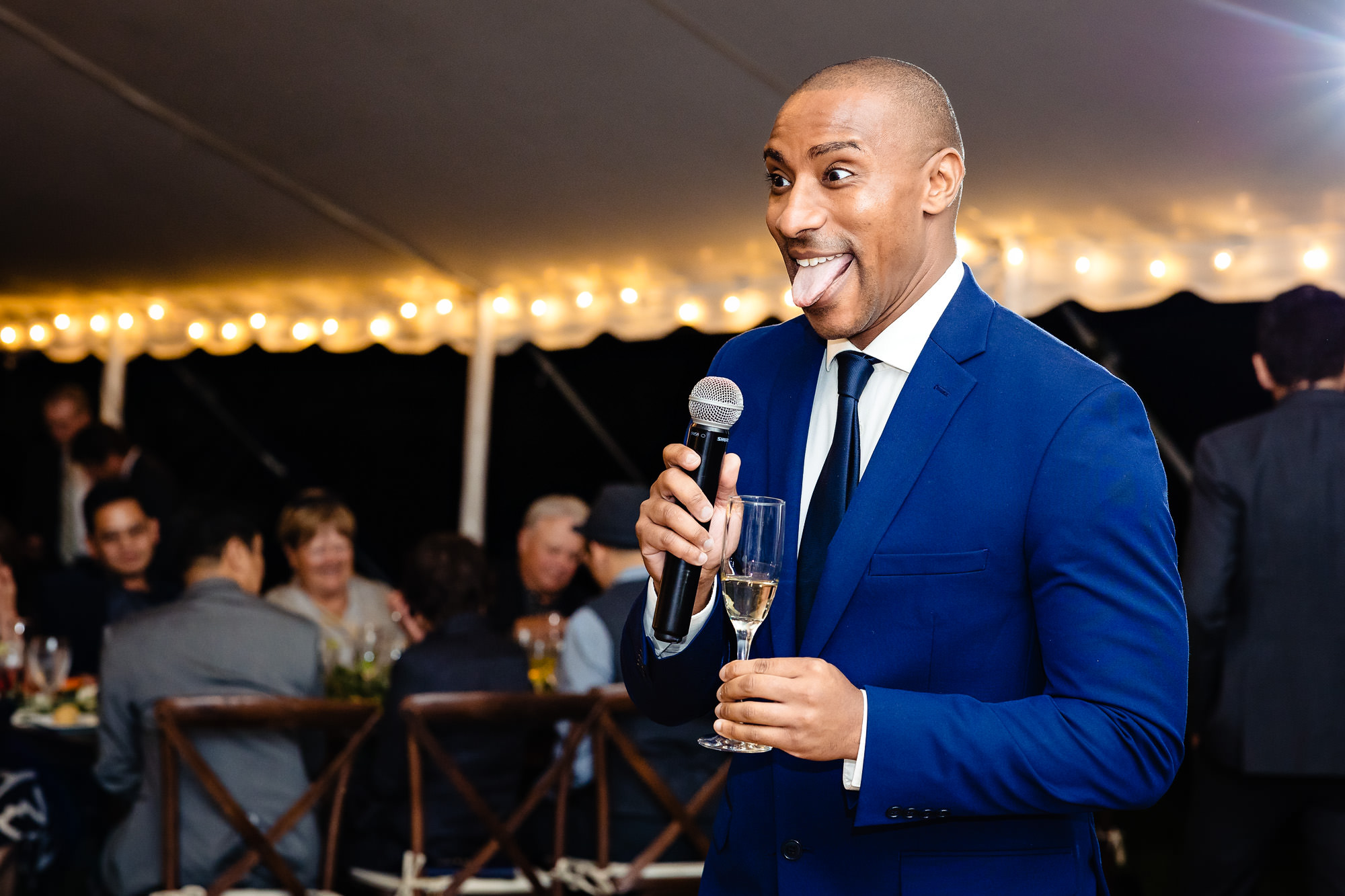 A friend shares a toast at a Rangeley Maine wedding