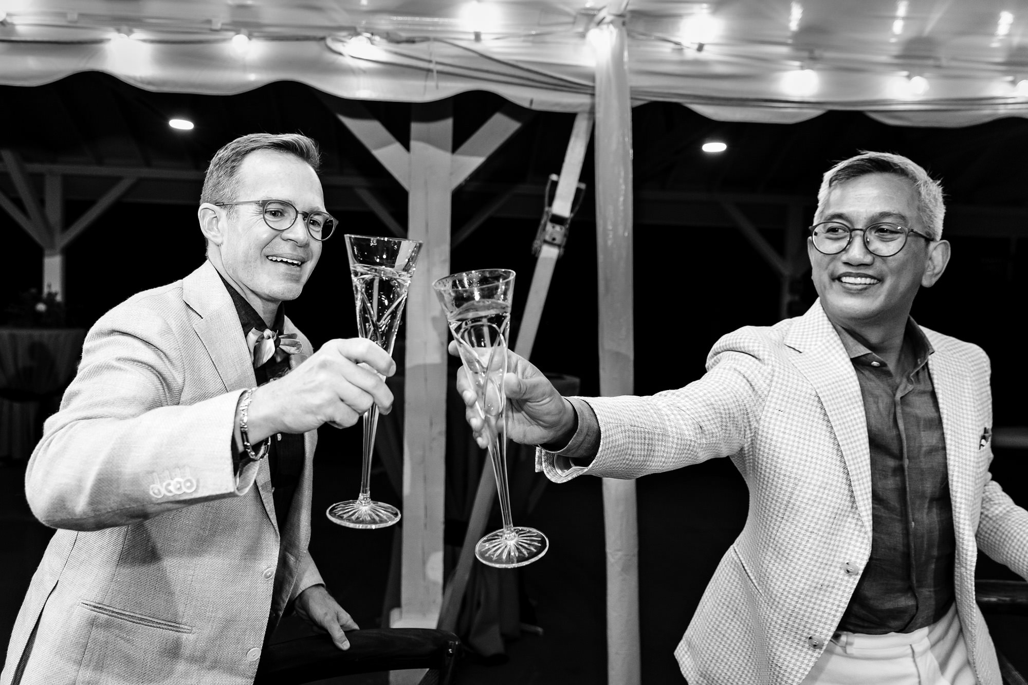 The grooms react to toasts during their wedding in Rangeley, Maine
