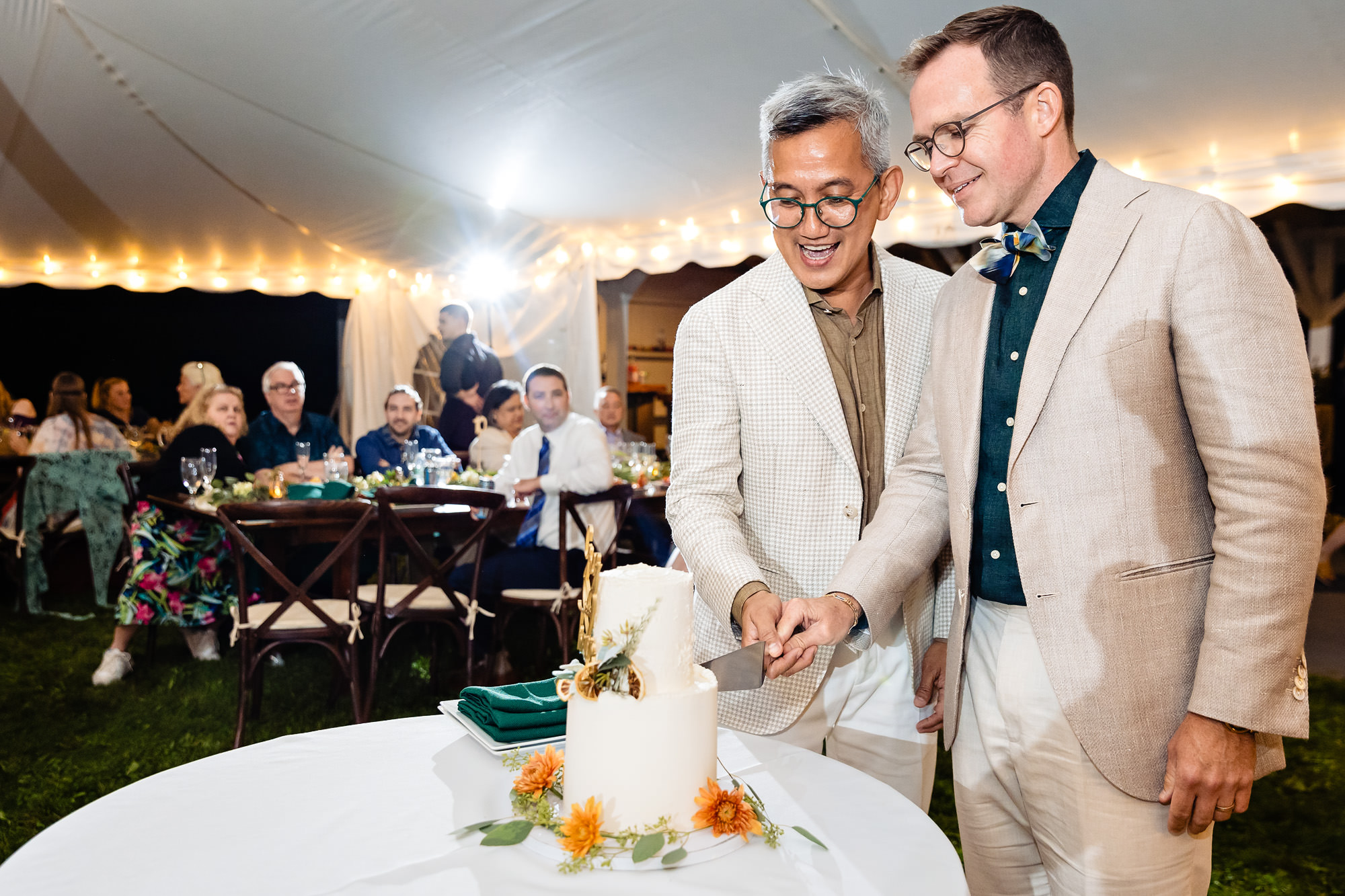 The grooms cut the cake at their wedding in western Maine
