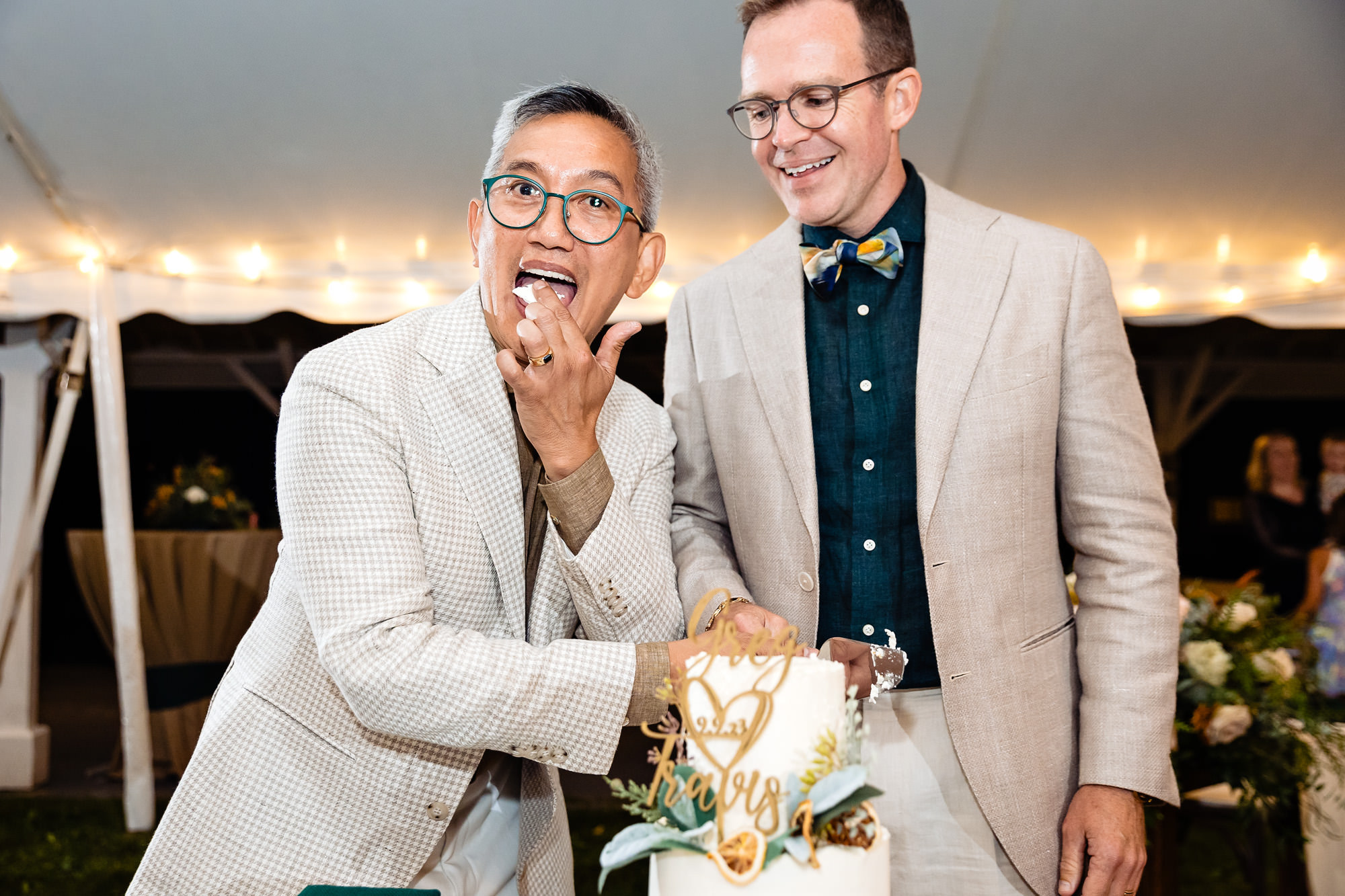 The grooms cut the cake at their wedding in western Maine