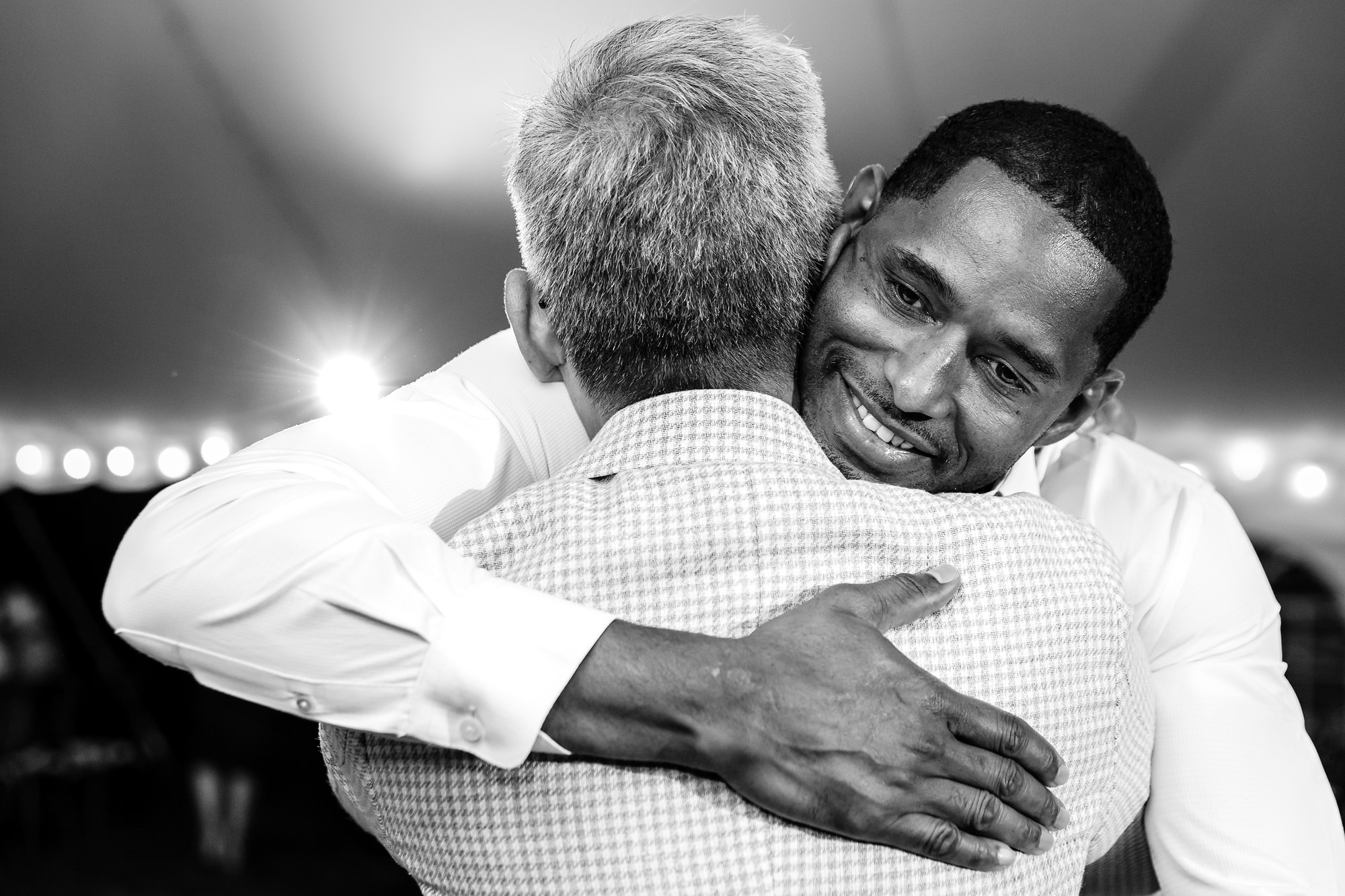 The grooms react to toasts during their wedding in Rangeley, Maine