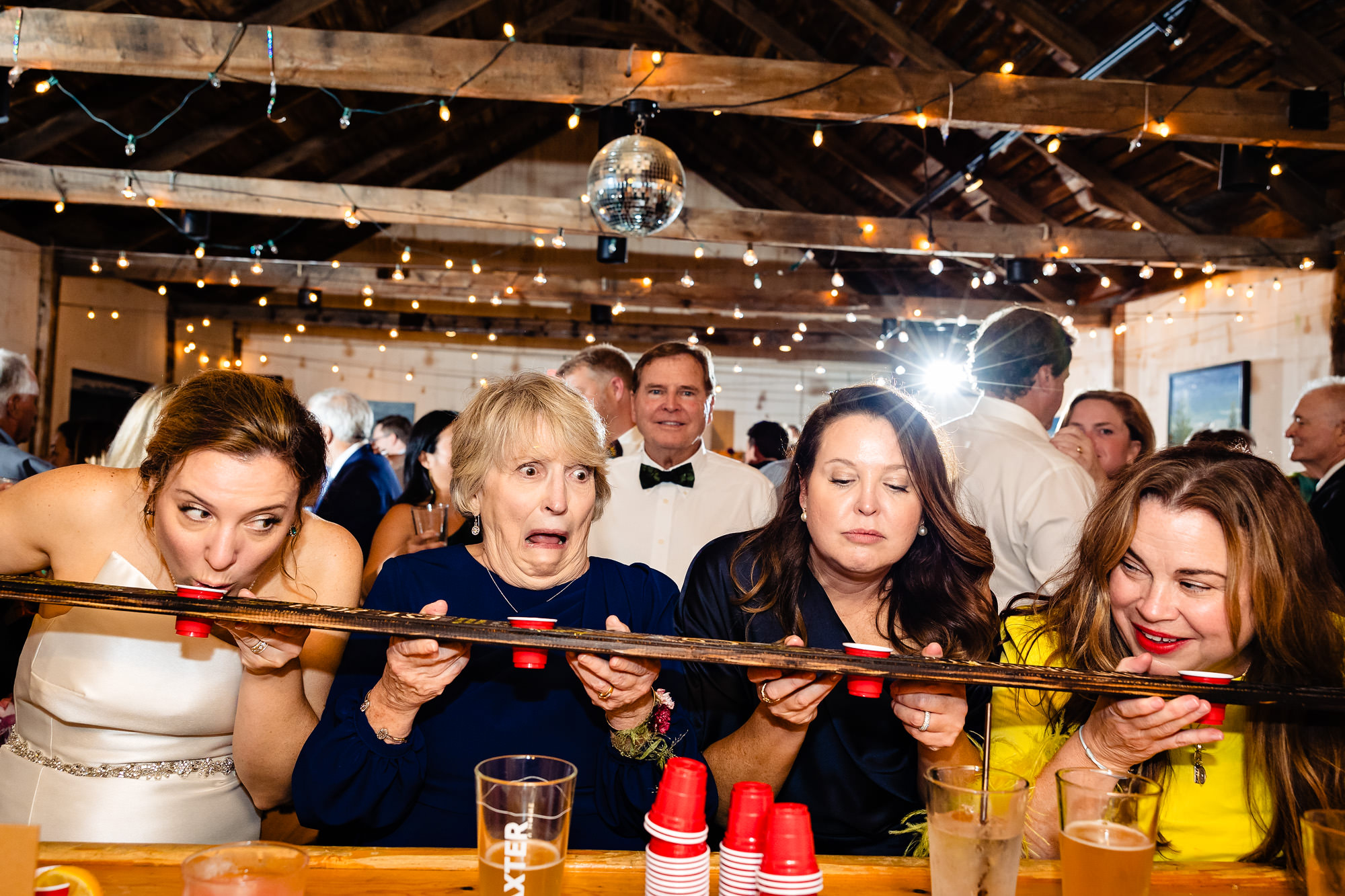 The bride and her family do a shotski at a Islesford Dock Restaurant wedding