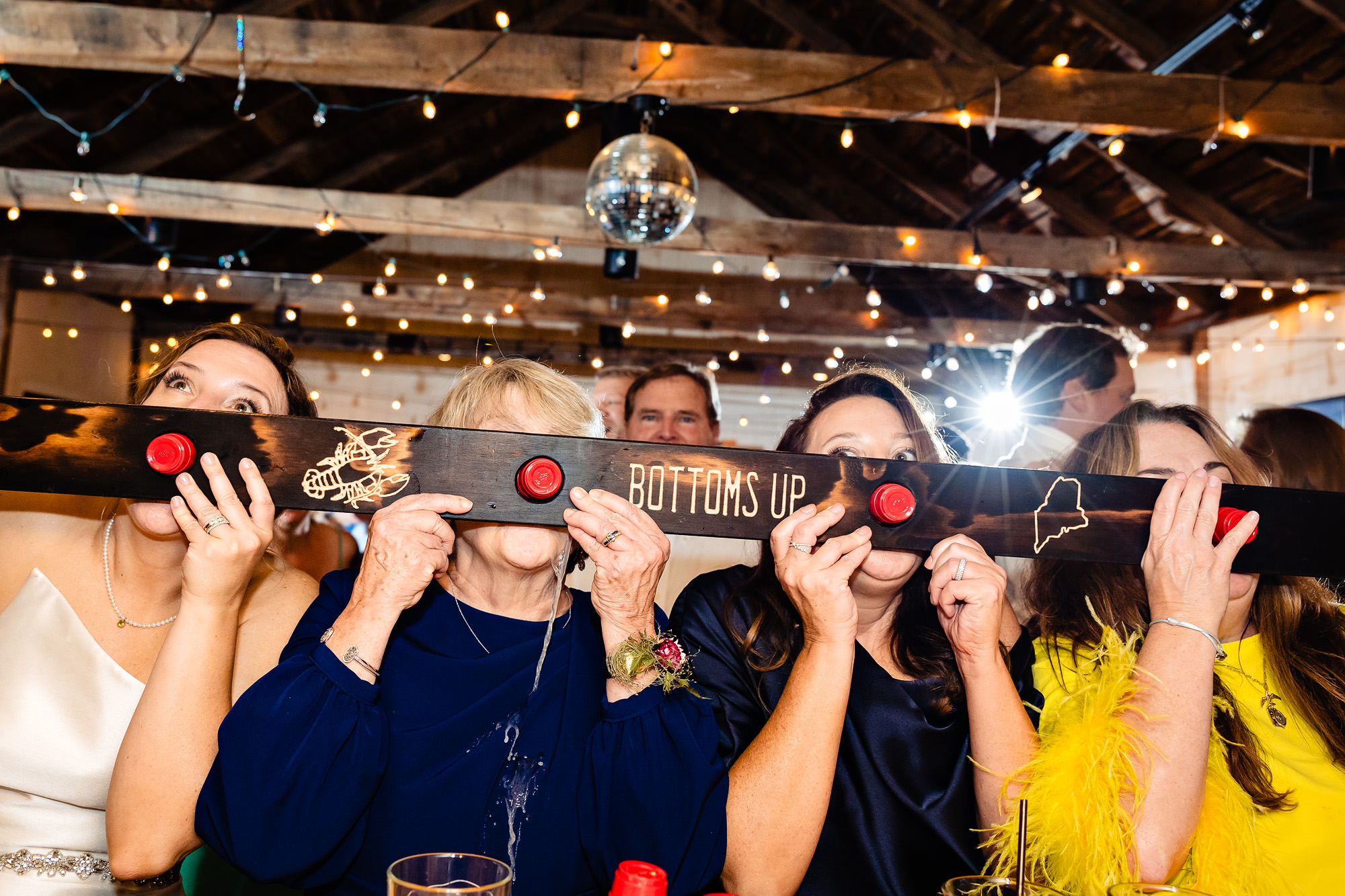 The bride and her family do a shotski at a Islesford Dock Restaurant wedding