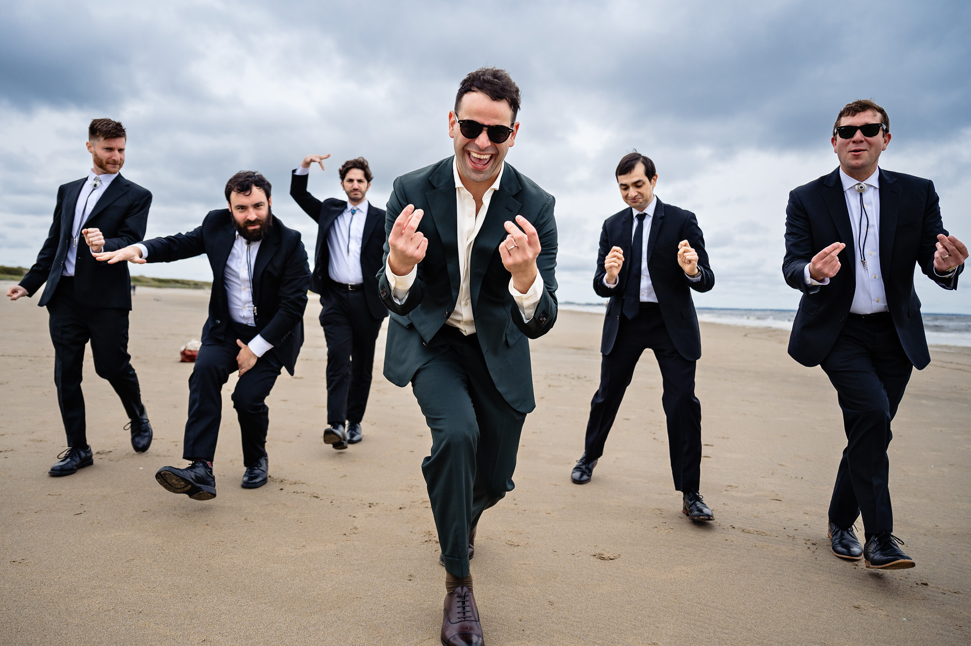 The groom and his groomsmen played around on a beach in Ogunquit Maine