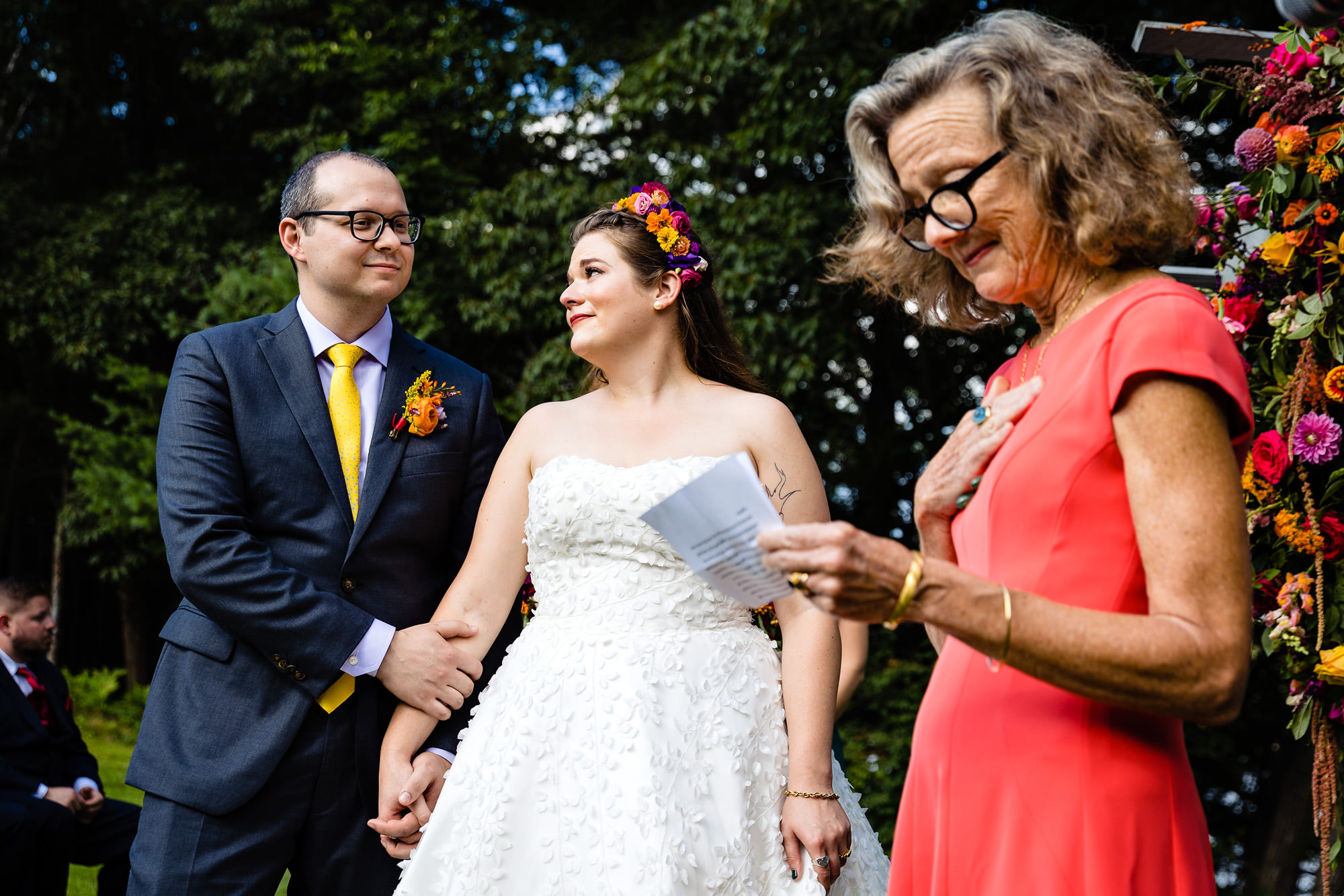 A couple looks at each other emotionally during a reading at a wedding ceremony